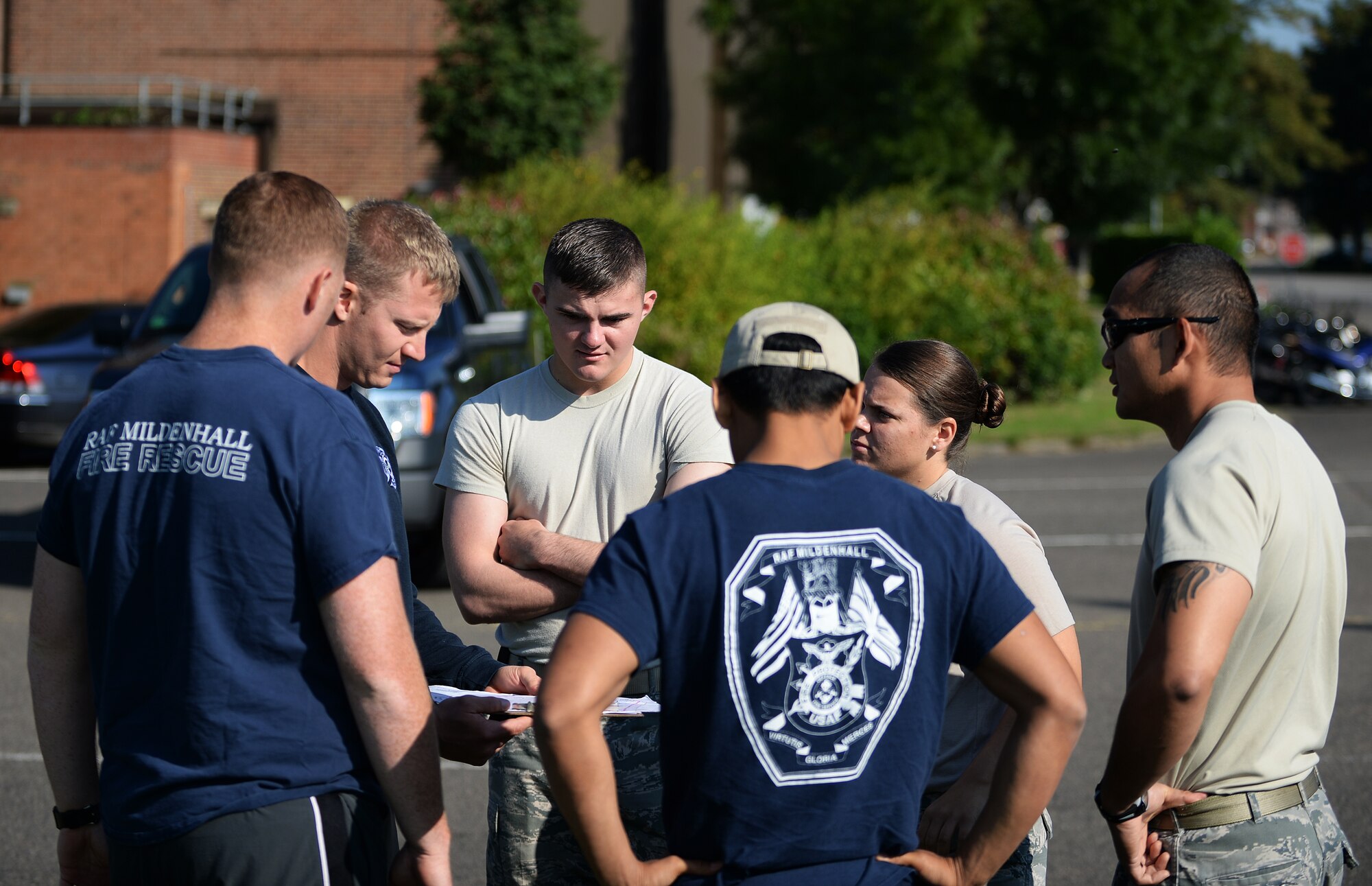 Members of the 100th Security Forces Squadron and 100th Civil Engineer Squadron look over a running course map during Warrior Challenge between Royal Air Forces Lakenheath and Mildenhall defenders and firefighters as part of Battle of the Badges competition on RAF Feltwell, England, Sept. 8, 2014. The week-long athletic competition was a joint effort as part of a Sept. 11 commemoration for first responders. (U.S. Air Force photo by Staff Sgt. Emerson Nuñez/Released) 