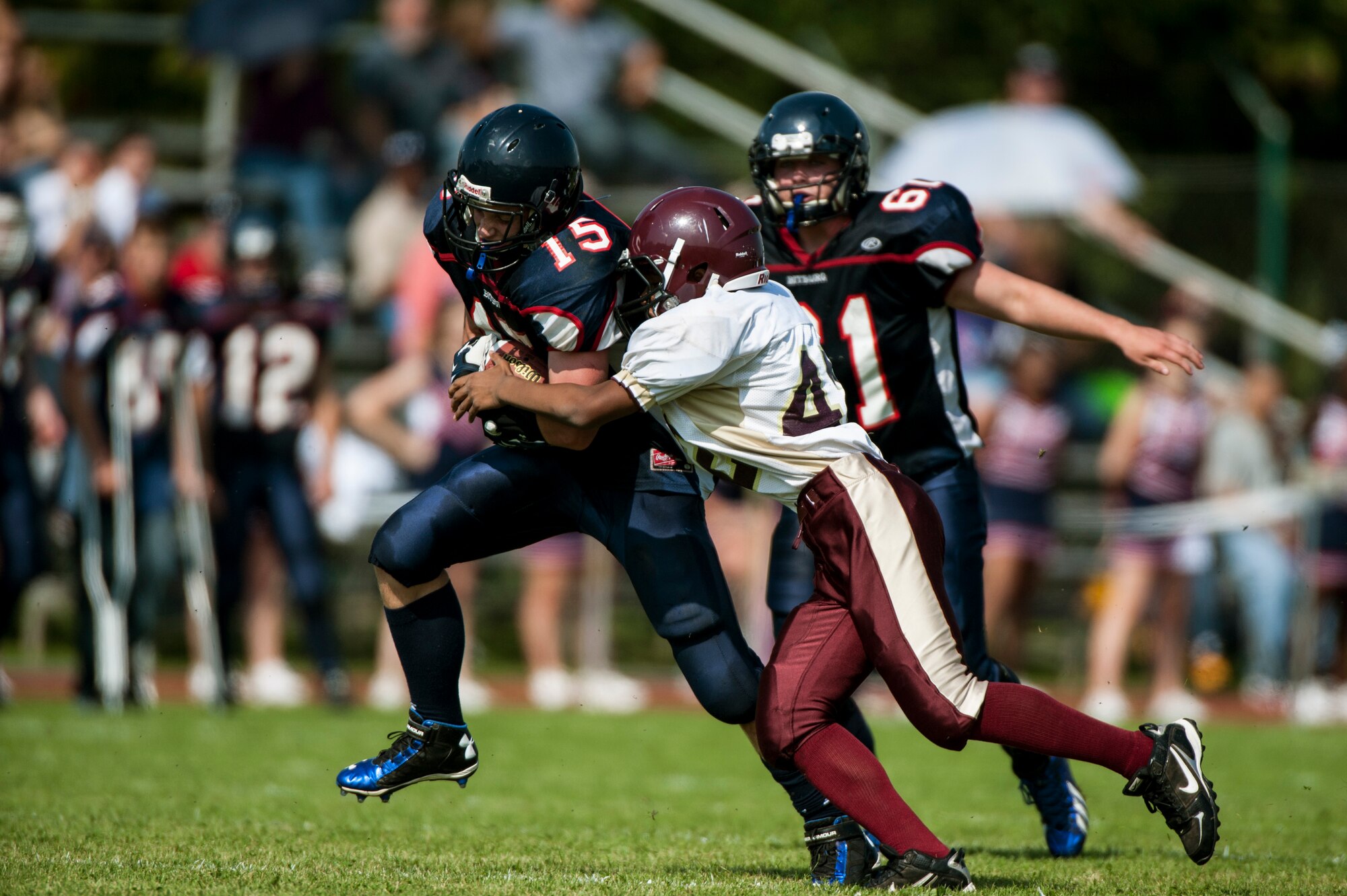 John Blake, a Bitburg Barons football team tight end, runs with the ball during a game against the Baumholder Buccaneers Sept. 6, 2014, at Bitburg Annex, Germany. The Barons won the game 32-8. (U.S. Air Force photo by Senior Airman Rusty Frank/Released)