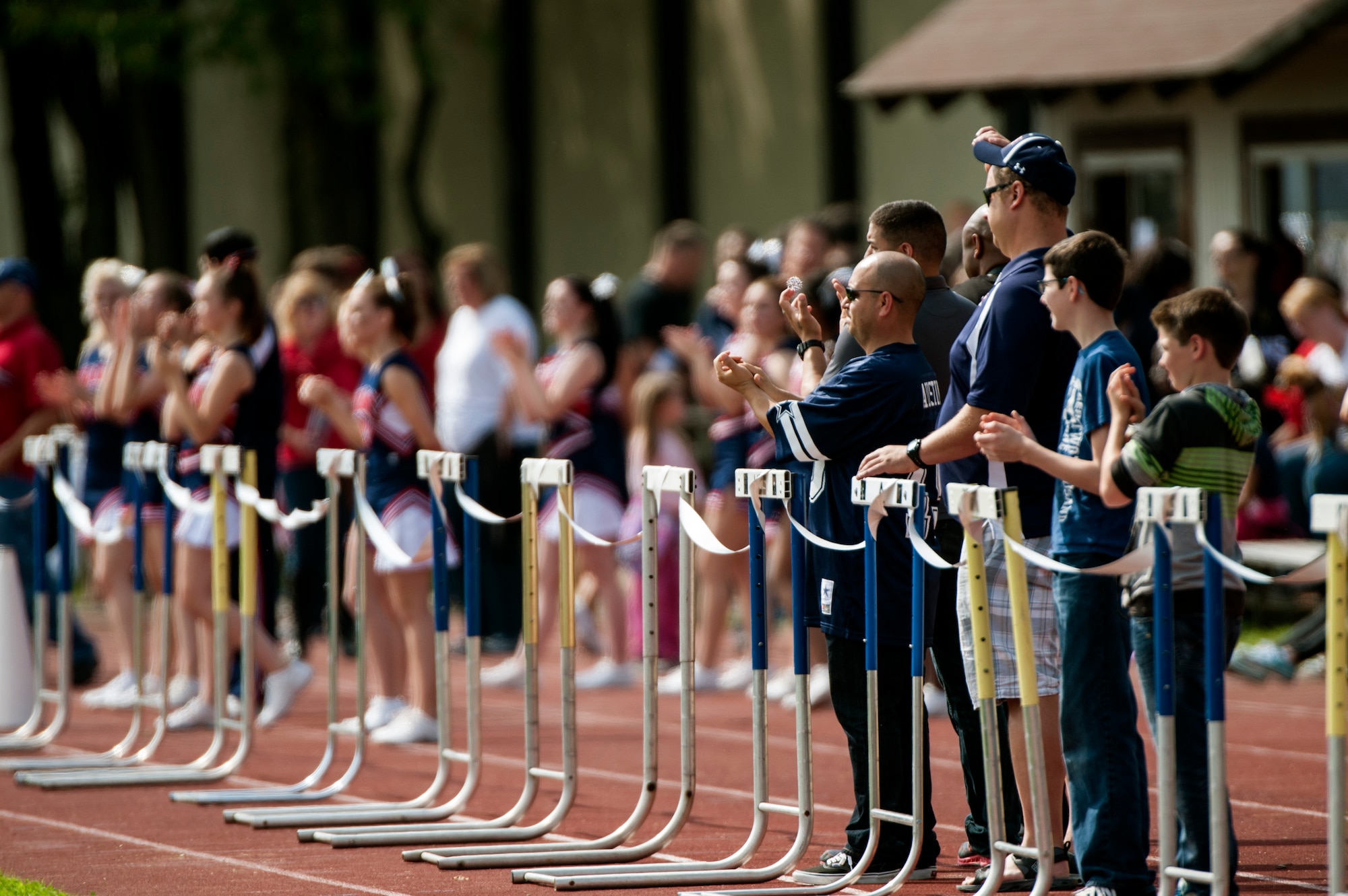 Fans cheer for the Bitburg Barons football team during the season opener game against the Baumholder Buccaneers Sept. 6, 2014, at Bitburg Annex, Germany. By half time, the Barons led the Buccaneers 12-8. (U.S. Air Force photo by Senior Airman Rusty Frank/Released)