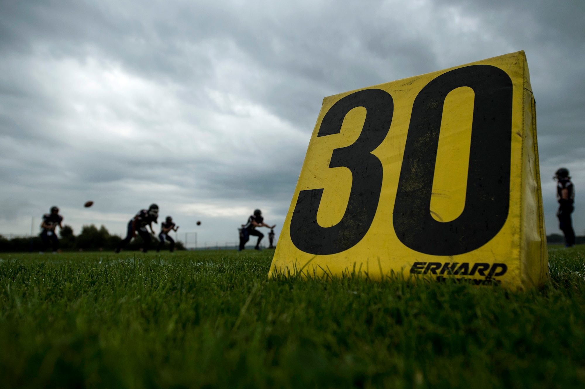 Members of the Bitburg Barons football team warm up prior to the start of their season opener game against the Baumholder Buccaneers Sept. 6, 2014, at Bitburg Annex, Germany. The Barons led 12-8 at the end of the 1st quarter. (U.S. Air Force photo by Senior Airman Rusty Frank/Released)