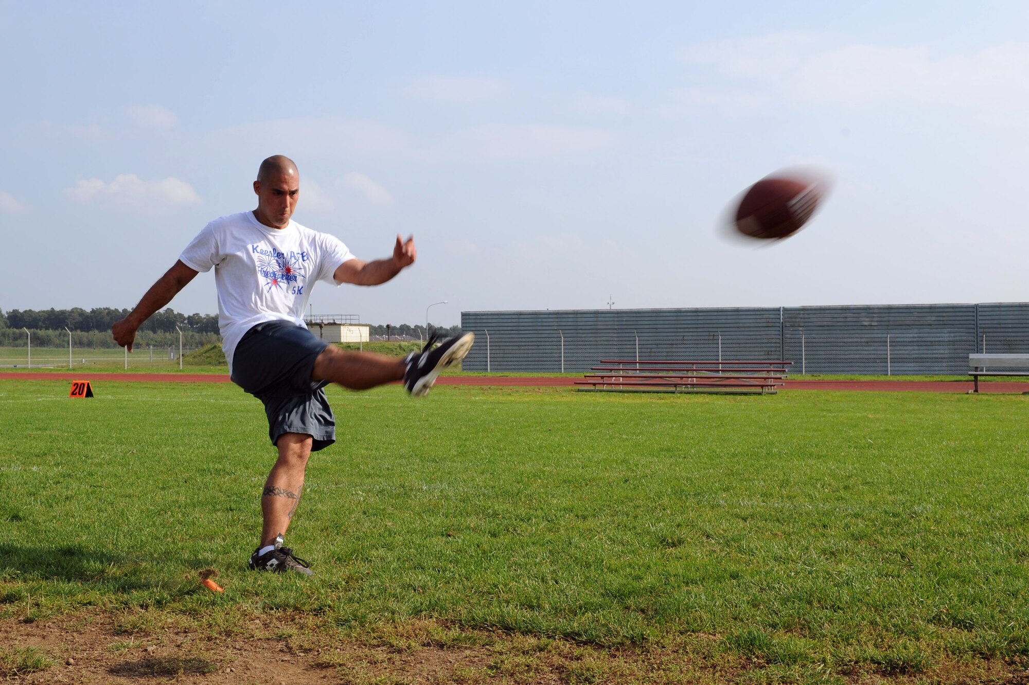 U.S. Air Force Tech. Sgt. James Yerger, 52nd Fighter Wing Safety ground safety manager, kicks a football during a field-goal competition at the 2014 Combined Federal Campaign-Overseas kickoff Sept. 8, 2014, at Spangdahlem Air Base, Germany. The campaign offers people an opportunity to donate money to more than 2,600 national, international and public philanthropic organizations. (U.S. Air Force photo by Airman 1st Class Dylan Nuckolls/Released)