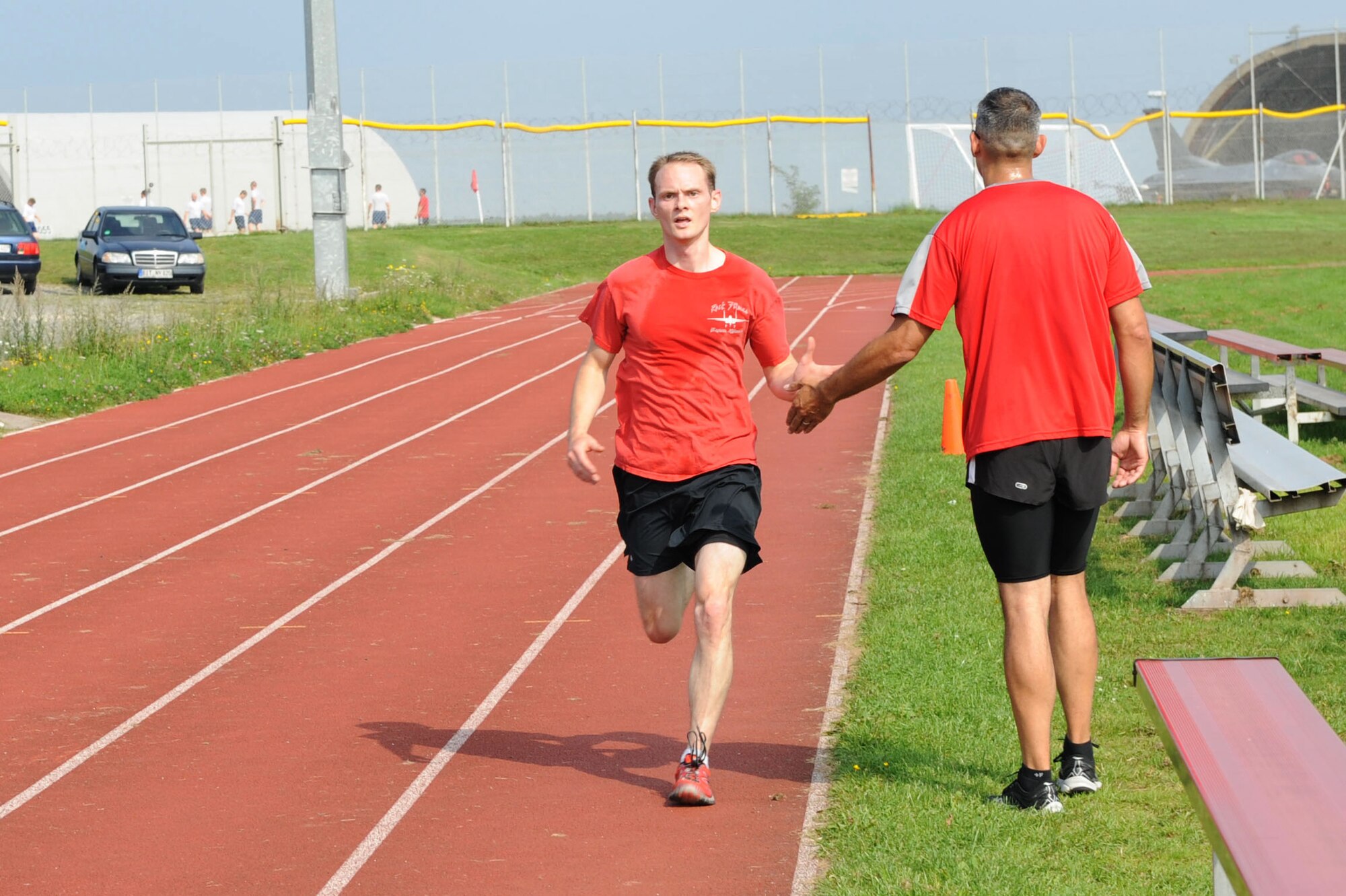 U.S. Army Sgt. 1st Class Mica Snell, 480th Fighter Squadron ground liaison officer from Wichita, Kan., right, high-fives an Airman finishing a 5K during the 2014 Combined Federal Campaign-Overseas kickoff Sept. 8, 2014, at Spangdahlem Air Base, Germany. Each unit has a CFC-O representative who can help Airmen make donations during the two-month campaign. (U.S. Air Force photo by Airman 1st Class Dylan Nuckolls/Released)