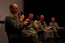 Maj. Timothy Grady, 8th Civil Engineering Squadron operations flight commander, provides the Wolf Pack with information regarding dormitory facilities during a town hall meeting in the base theater at Kunsan Air Base, Republic of Korea, Sept. 8, 2014. A panel of wing leadership met with Airmen during three town hall sessions to hear their concerns regarding quality of life issues at Kunsan Air Base. (U.S. Air Force photo by Senior Airman Taylor Curry/Released) 