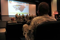 Col. Ken “Wolf” Ekman, 8th Fighter Wing commander, addresses an Airman’s question during a town hall meeting in the base theater at Kunsan Air Base, Republic of Korea, Sept. 8, 2014. Wolf invited 8 FW Airmen to attend one of three offered sessions to discuss quality of life issues with a panel of base leadership.  (U.S. Air Force photo by Senior Airman Taylor Curry/Released)