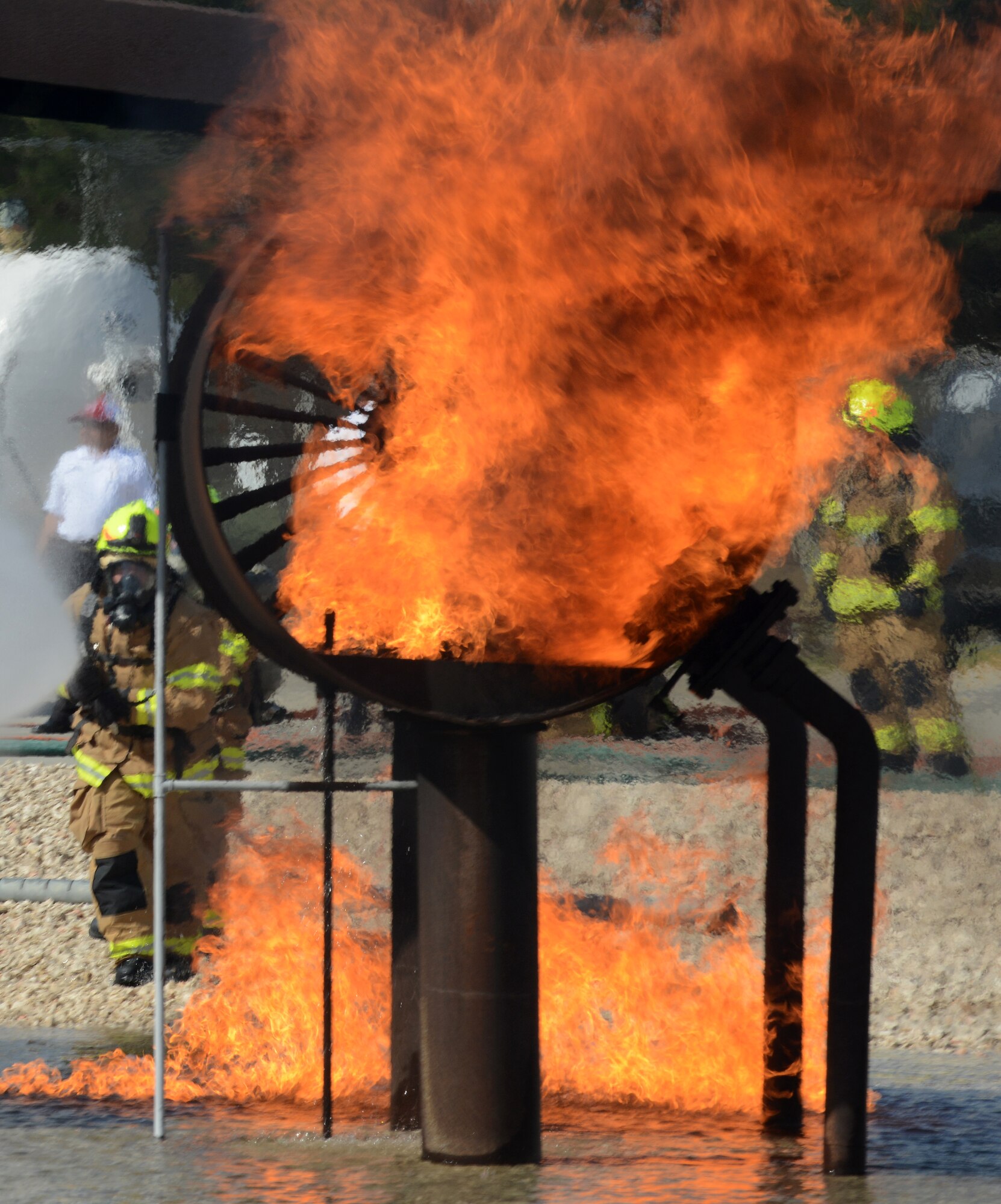 Firefighters from the 39th Civil Engineer Squadron Incirlik Fire Emergency Services, battle an aircraft live fire during annual training, Sept. 9, 2014, at Incirlik Air Base, Turkey. The firefighters are trained in a number of services to provide the best response capabilities to the 39th Air Base Wing and the Turkish air force 10th Tanker base. (U.S. Air Force photo by Staff Sgt. Caleb Pierce/Released)