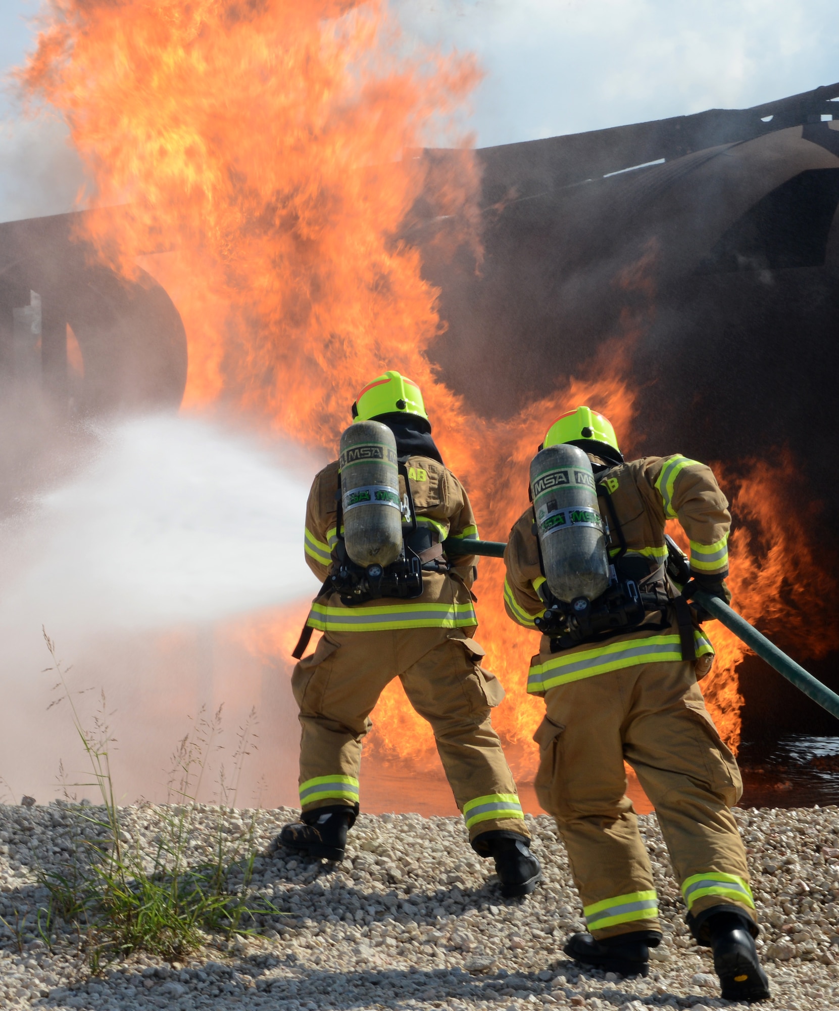Firefighters from the 39th Civil Engineer Squadron Incirlik Fire Emergency Services, participate in annual aircraft live fire training, Sept. 9, 2014, at Incirlik Air Base, Turkey. The training is a requirement for all firefighters to remain current in their job qualifications. (U.S. Air Force photo by Staff Sgt. Caleb Pierce/Released)