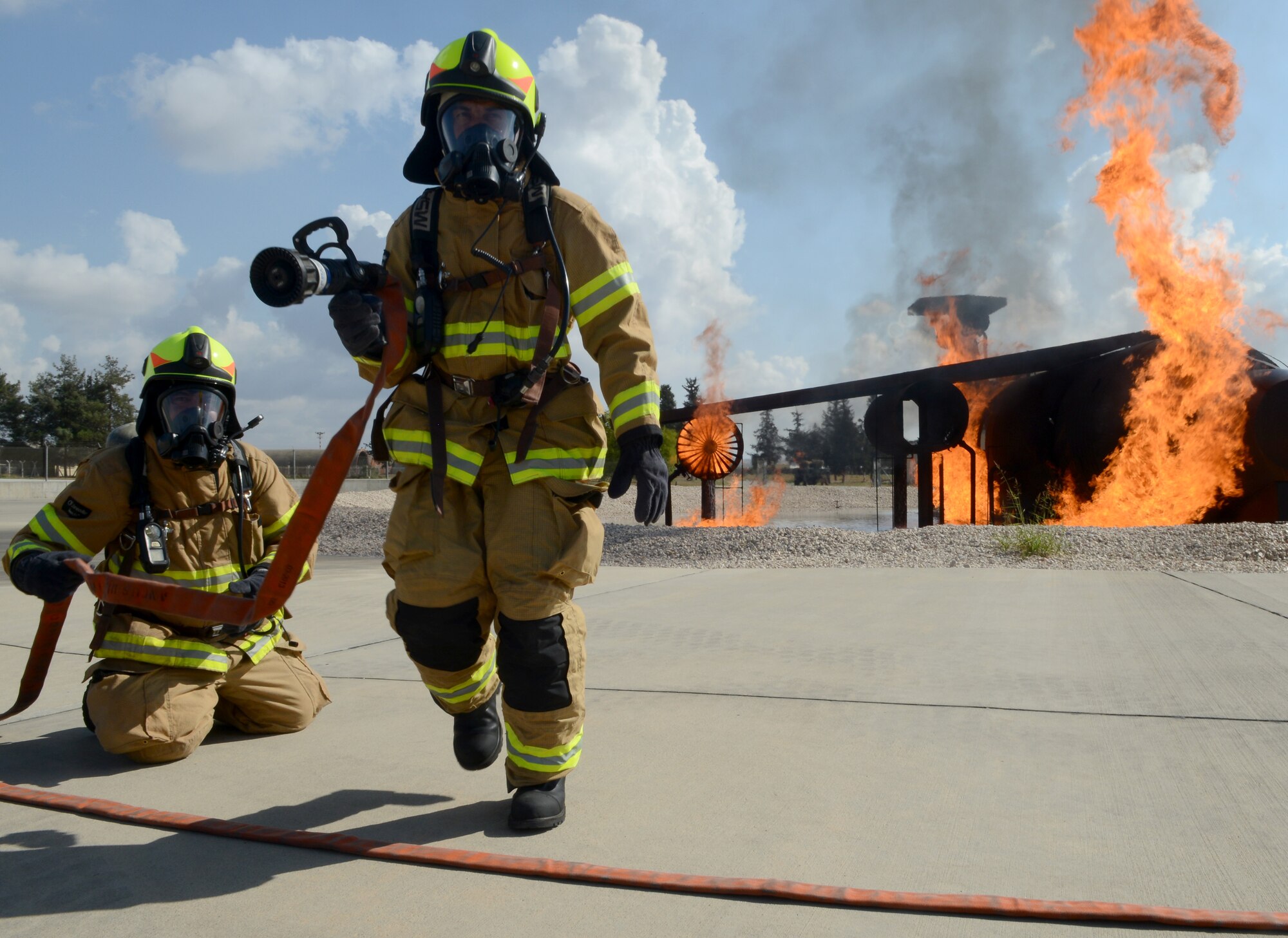 Firefighters from the 39th Civil Engineer Squadron Incirlik Fire Emergency Services, prepare for annual aircraft live fire training, Sept. 9, 2014, at Incirlik Air Base, Turkey. There are more than 80 firefighters in the Incirlik Fire Emergency Services. (U.S. Air Force photo by Staff Sgt. Caleb Pierce/Released)