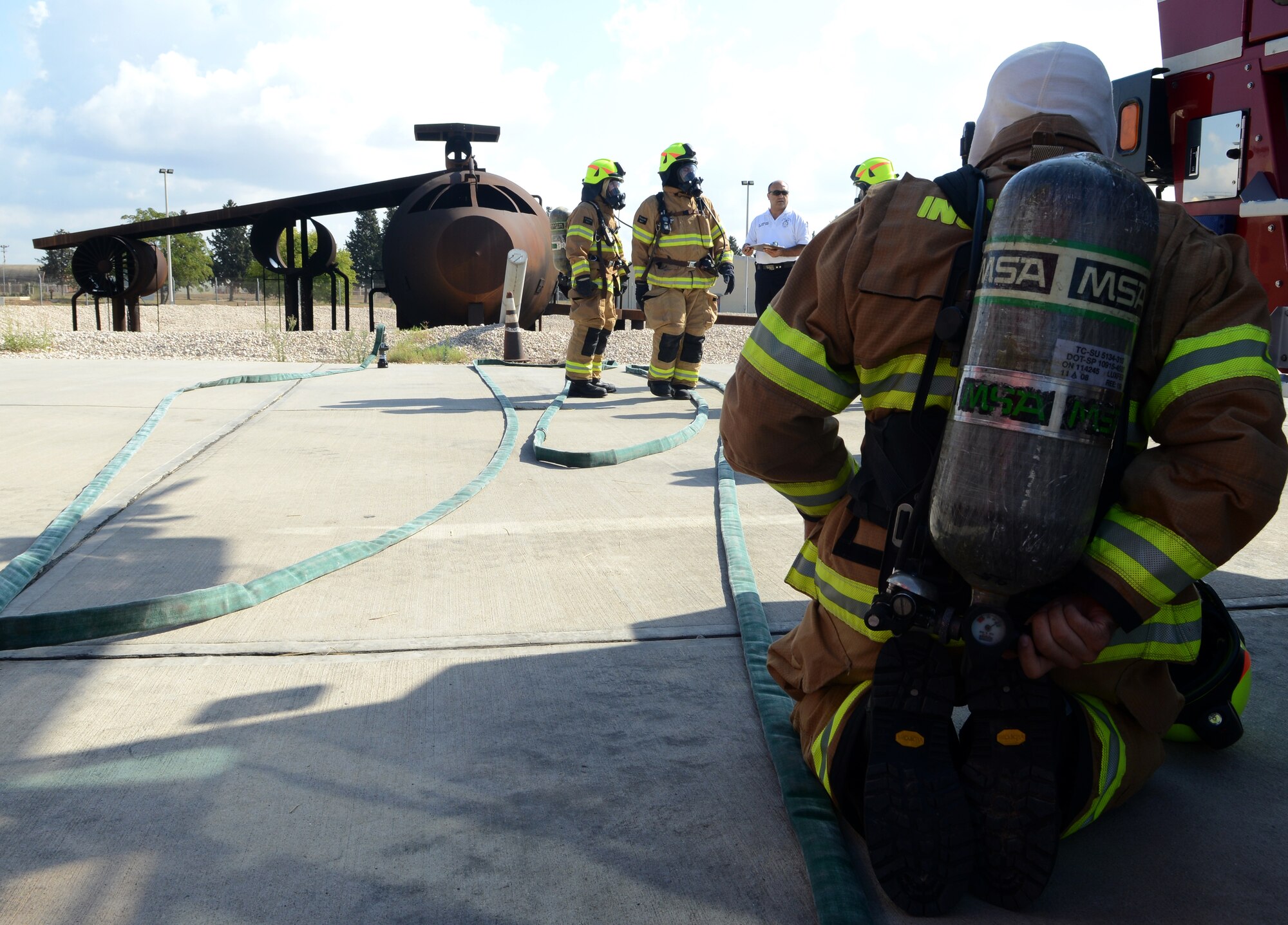 Firefighters from the 39th Civil Engineer Squadron Incirlik Fire Emergency Services, prepare for annual aircraft live fire training, Sept. 9, 2014, at Incirlik Air Base, Turkey. The firefighters participated in the training to meet requirements necessary to keep proficient in their qualifications. (U.S. Air Force photo by Staff Sgt. Caleb Pierce/Released)