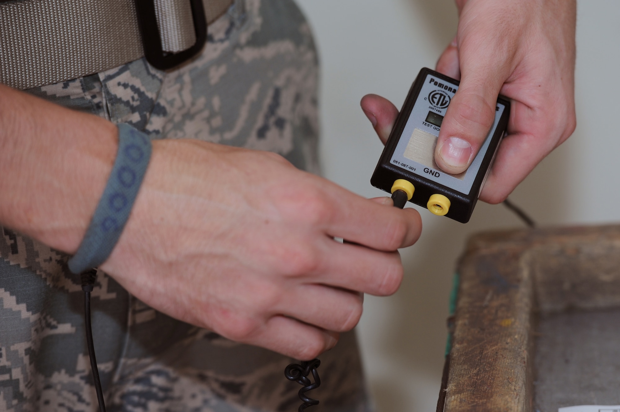 U.S. Air Force Airman 1st Class Cody Lasagna, 18th Munitions Squadron crew member, grounds himself with an antistatic system on Kadena Air Base, Japan, Sept. 4, 2014. When working with active munitions, Airmen are required to periodically ground themselves to remove any buildup of static electricity that could potentially detonate the assets. (U.S. Air Force photo by Airman 1st Class Zade C. Vadnais/Released)