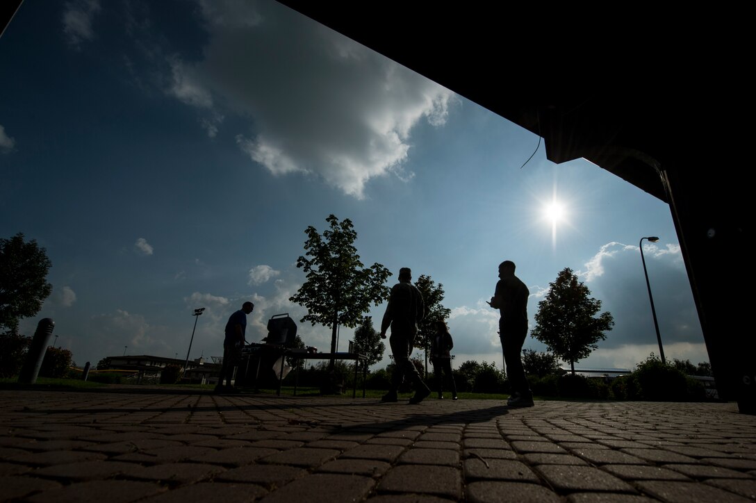 U.S. Air Force Master Sgt. Gary Landenberger, 52nd Force Support Squadron Airman and Family Readiness Center superintendent from Sysco, Texas, grills during the Adopt an Airman Program barbecue Sept. 5, 2014, at Spangdahlem Air Base, Germany. The event was held to promote the program and as a way for German families to meet their adopted Airmen. (U.S. Air Force photo by Senior Airman Rusty Frank/Released)