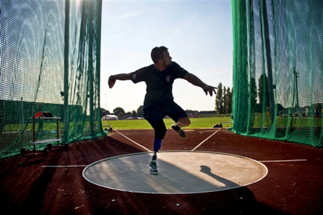 Retired Navy Petty Officer 3rd class Max Rohn winds up to throw a discus during training for the  Invictus Games in London, Sept. 8, 2014. U.S. Team members will train for three days before the competition. The international event is designed for injured, wounded and ill service members and veterans.