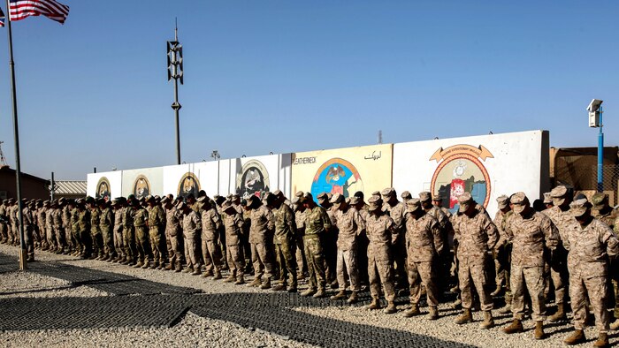 Marines, sailors and coalition partners with Regional Command (Southwest) bow their heads during a moment of silence at the 9/11 memorial ceremony aboard Camp Leatherneck, Afghanistan, Sept. 11, 2014. “That moment of silence gave us an opportunity to reflect and reminds us of why we are here today in Afghanistan in Helmand province,” said Brig. Gen. Daniel D. Yoo, commander, RC(SW) and Marine Expeditionary Brigade – Afghanistan.