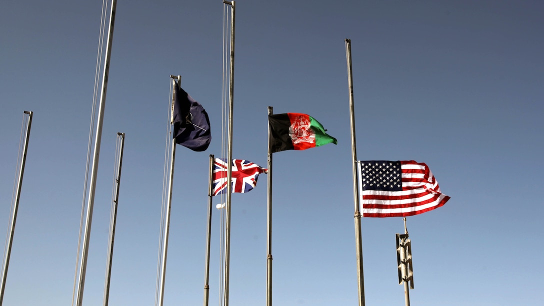 The American flag waves while flying at half-staff following the 9/11 ceremony held aboard Camp Leatherneck, Afghanistan, Sept. 11, 2014. The ceremony was attended by hundreds of Marines, sailors and coalition partners to commemorate the 13th anniversary of the terrorist attacks.