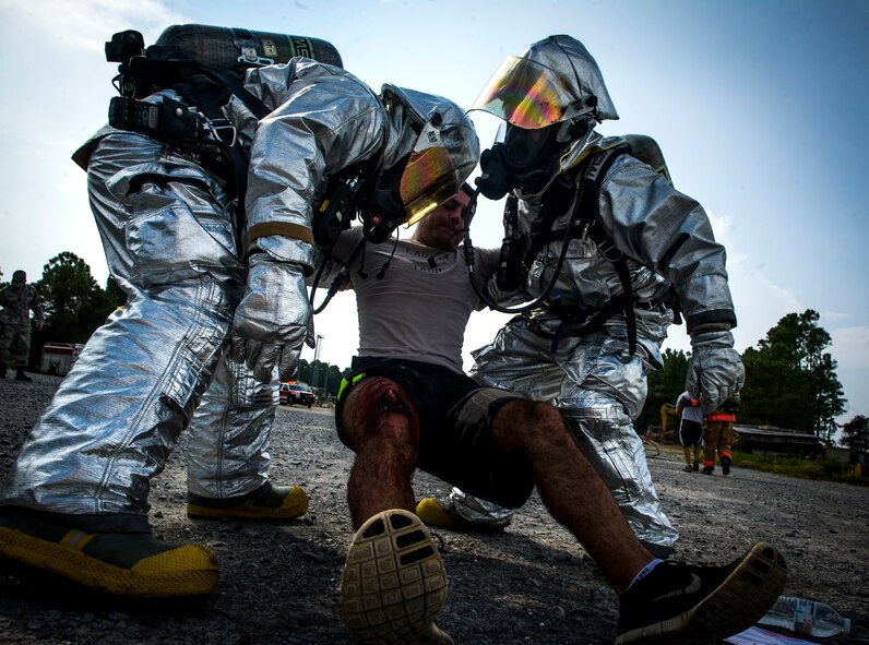 1st Special Operations Civil Engineer Squadron firefighters assist a role-playing victim during Exercise Commando Terror at Hurlburt Field, Fla., Sept. 8, 2014. During the exercise, Airmen responded to a simulated bomb explosion and assisted the affected victims. (U.S. Air Force photo/Senior Airman Christopher Callaway) 