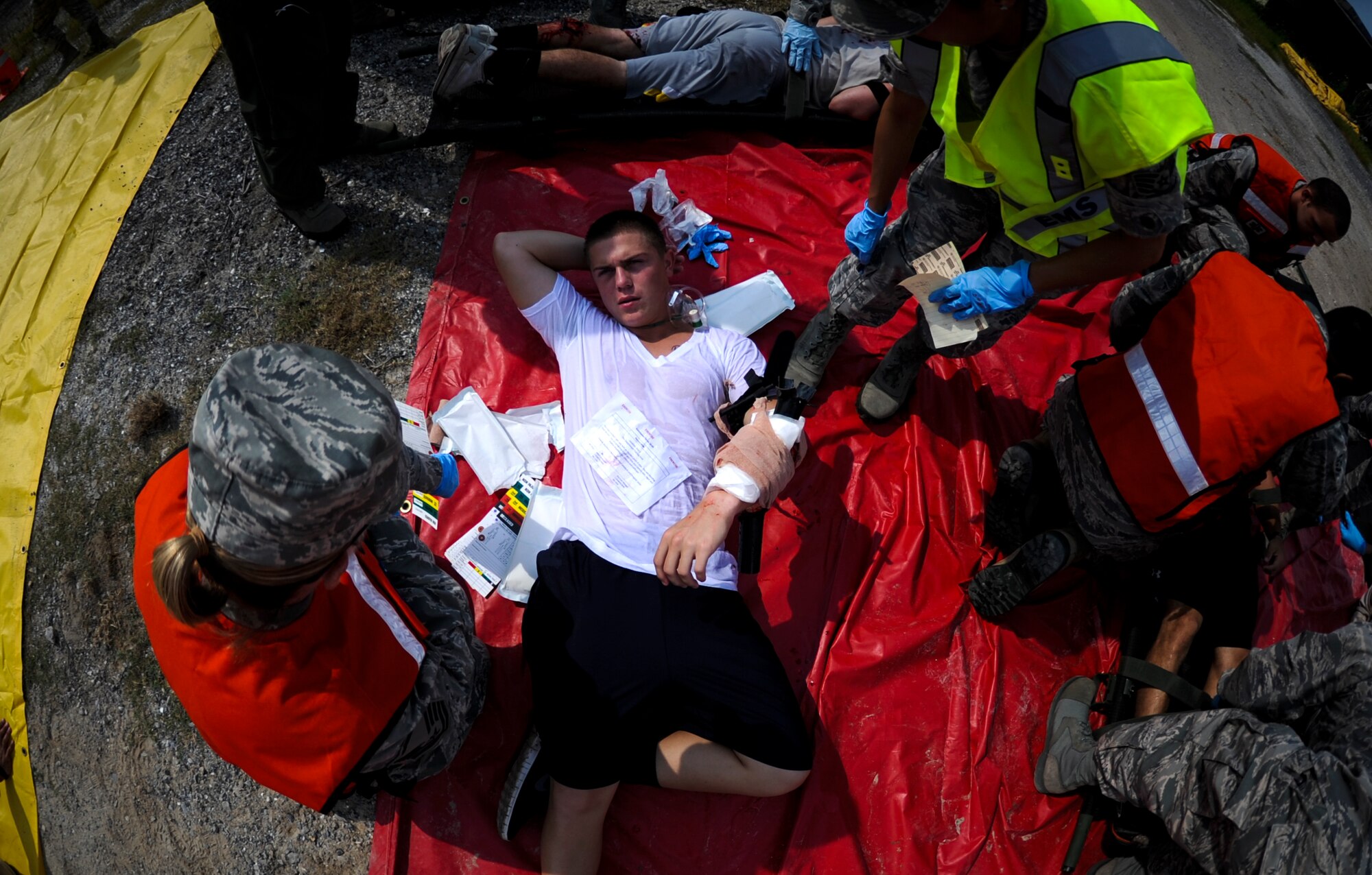 A role-playing victim receives medical care from 1st Special Operations Medical Group Airmen during Exercise Commando Terror at Hurlburt Field, Fla., Sept. 8, 2014. The 1st SOMDG teamed up with Okaloosa County Emergency Medical Services to provide medical support to the simulated victims. (U.S. Air Force photo/Senior Airman Christopher Callaway) 