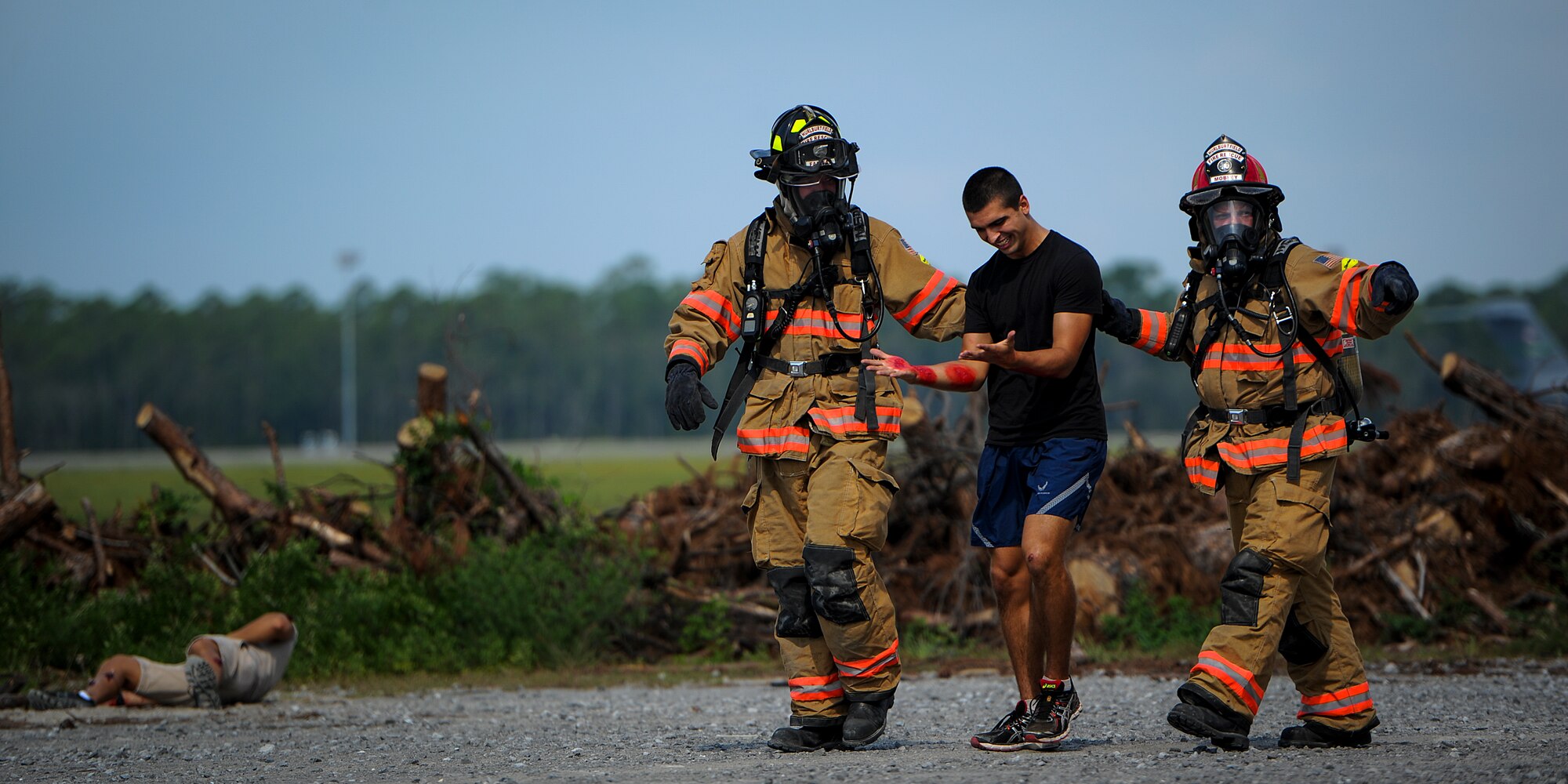 1st Special Operations Civil Engineer Squadron firefighters assist a role-playing victim during Exercise Commando Terror at Hurlburt Field, Fla., Sept. 8, 2014. During the exercise, Airmen responded to a simulated bomb explosion and assisted the affected victims. (U.S. Air Force photo/Senior Airman Christopher Callaway) 