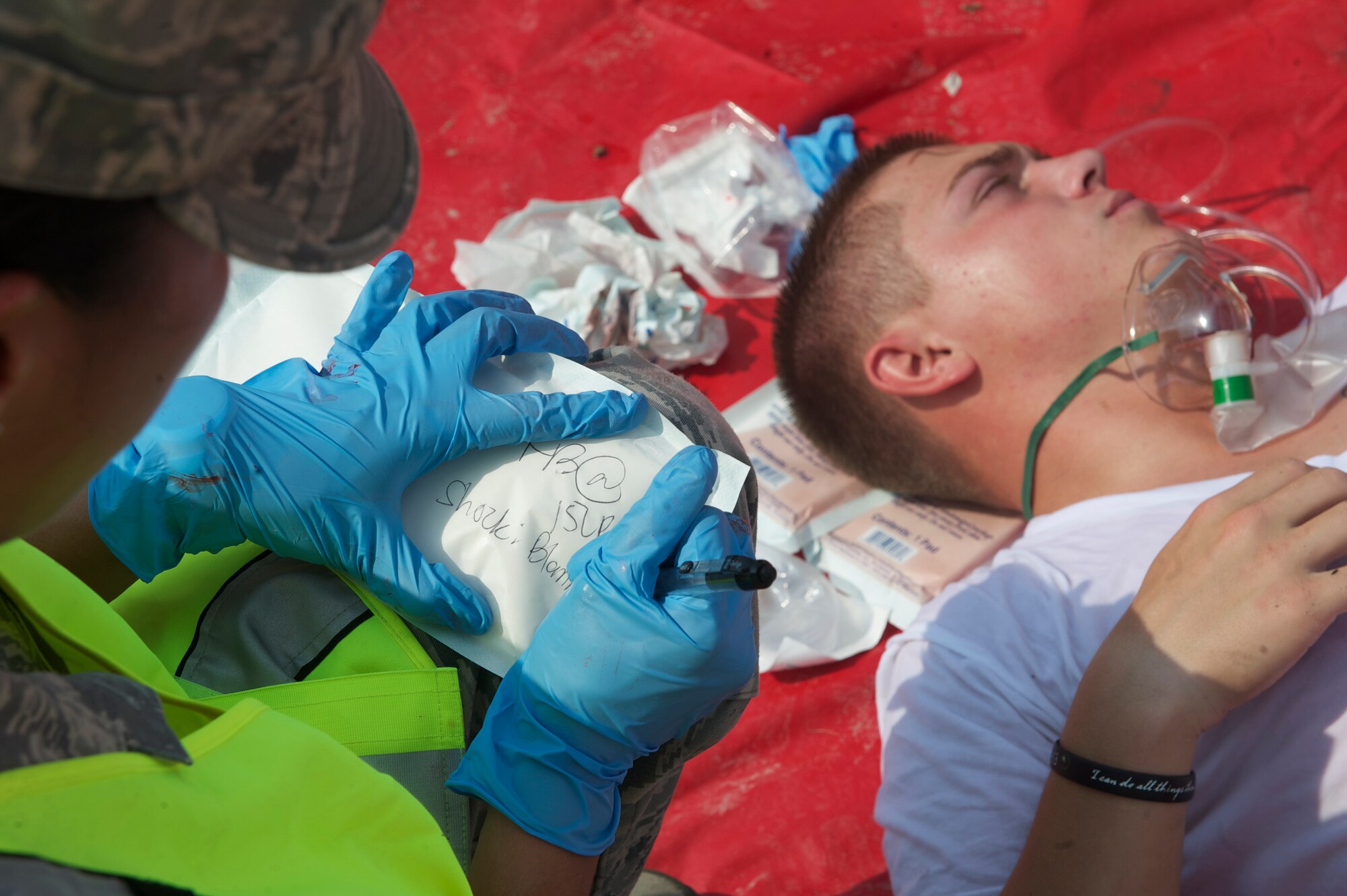 A 1st Special Operations Medical Group Airman writes down signs and symptoms of a role-playing victim during Exercise Commando Terror at Hurlburt Field, Fla., Sept. 8, 2014. The 1st SOMDG teamed up with Okaloosa County Emergency Medical Services to provide medical support to the simulated victims. (U.S. Air Force photo/Senior Airman Christopher Callaway)
