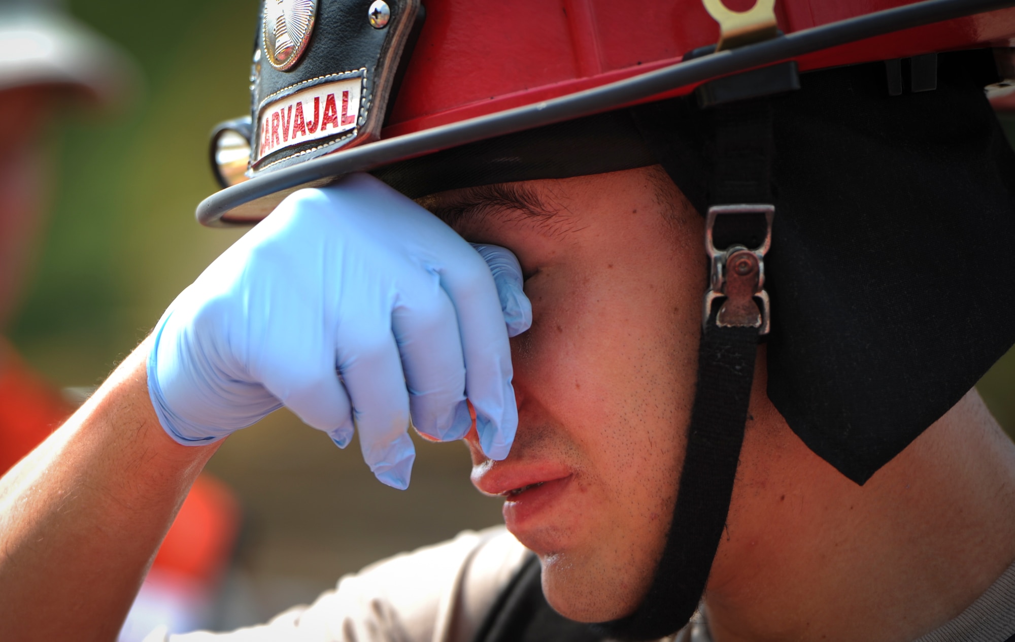 A firefighter from the 1st Special Operations Civil Engineer Squadron wipes his face during Exercise Commando Terror at Hurlburt Field, Fla., Sept. 8, 2014. The exercise tested the first responder’s ability to react to a domestic bomb explosion on base. (U.S. Air Force photo/Senior Airman Christopher Callaway) 