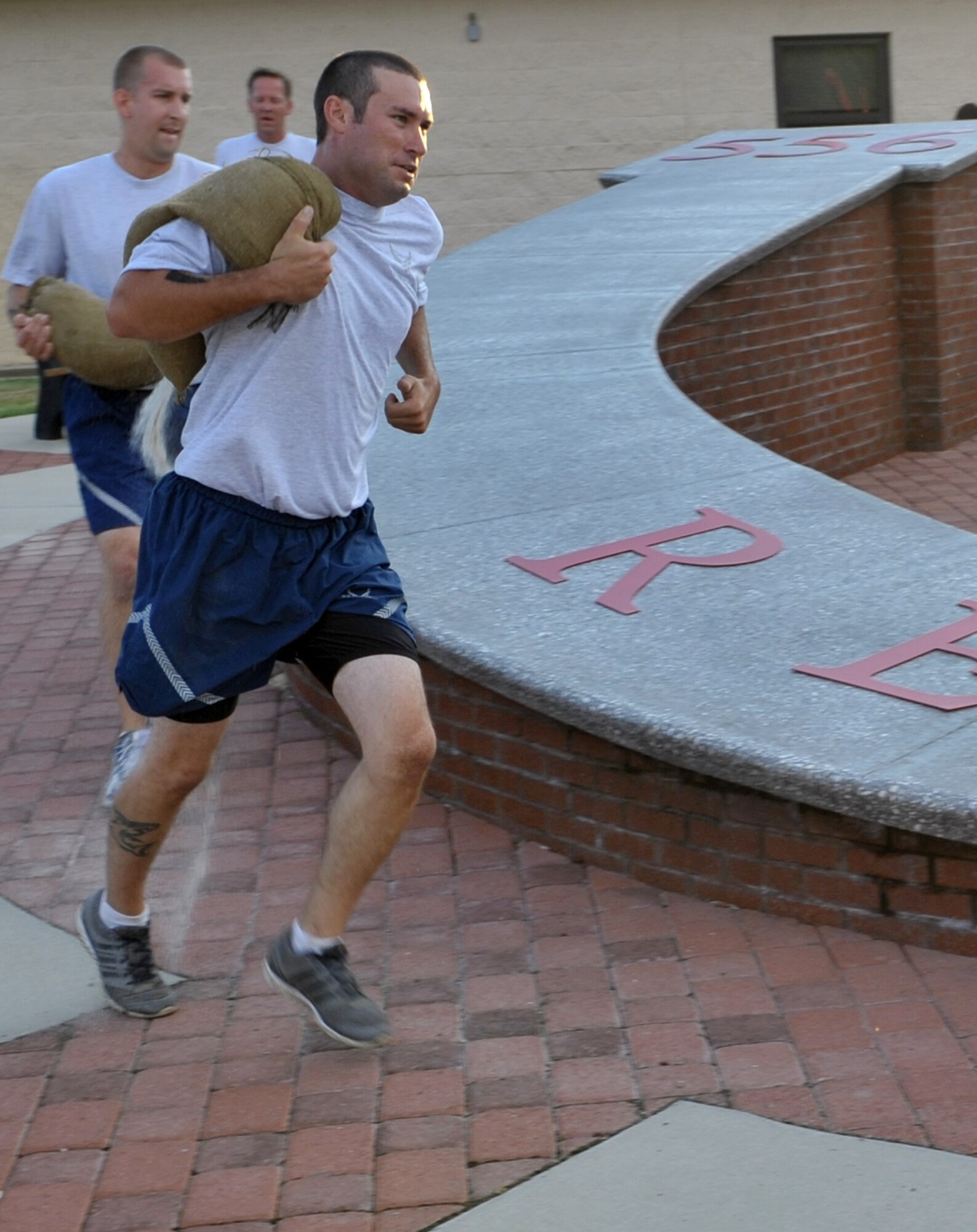 Airman 1st Class Ryan Holland carries a sandbag during the 2014 RED HORSE Rumble Obstacle course, Sept. 6, 2014 at Hurlburt Field, Fla. The sandbag carry is the last obstacle of the course, before ending with a 100-meter sprint to the finish line. (U.S. Air Force photo/Senior Airman Kentavist P. Brackin)