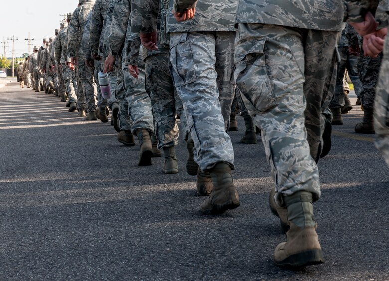 The Wolf Pack marches across base during a silent walk honoring the 13th anniversary of Sept. 11, 2001, at Kunsan Air Base, Republic of Korea. The event served not only to honor those who made the ultimate sacrifice, but also as a reminder to Wolf Pack Airmen of the American freedoms they ensure every day as defenders of the base against external threats in wartime and armistice alongside ROK allies. (U.S. Air Force photo by Senior Airman Katrina Heikkinen)