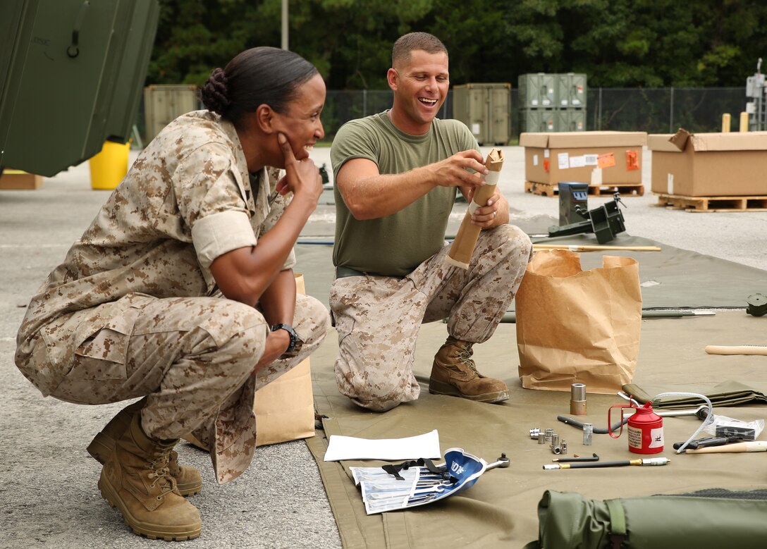 Sgt. Maj. Robin C. Fortner, left, sergeant major of the Ground Combat Element Integrated Task Force, speaks with Sgt. Jason McMullen, light armored vehicle crewman, Company B, GCEITF, during a limited technical inspection at the 2nd Light Armored Reconnaissance Battalion ramp, Sept. 9, 2014. Each vehicle came with dozens of tools and upkeep equipment. From October 2014 to July 2015, the GCEITF will conduct individual and collective level skills training in designated ground combat arms occupational specialties in order to facilitate the standards-based assessment of the physical performance of Marines in a simulated operating environment performing specific ground combat arms tasks. (Official Marine Corps photo by Cpl. Paul S. Martinez/Released)