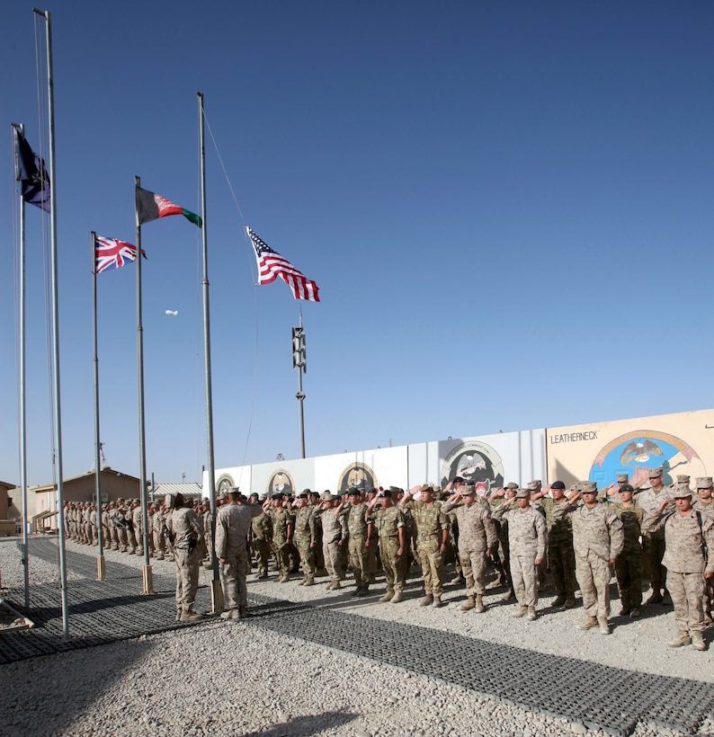 Marines, sailors and coalition partners with Regional Command (Southwest) salute while the American flag is raised at the RC(SW) headquarters during a 9/11 memorial ceremony aboard Camp Leatherneck, Afghanistan, Sept. 11, 2014. “For Americans, 9/11 evokes a very special meaning. It’s a memory of the world as we knew it on that day changing forever. Today’s simple but solemn ceremony is a tribute to those innocent young men, women and children who were killed by a cowardly and heartless act of terror,” said Brig. Gen. Daniel D. Yoo, commander, RC(SW) and Marine Expeditionary Brigade – Afghanistan.
