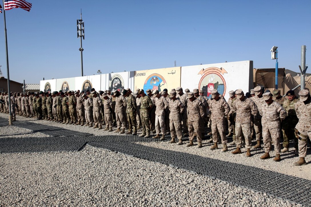 Marines, sailors and coalition partners with Regional Command (Southwest) bow their heads during a moment of silence at the 9/11 memorial ceremony aboard Camp Leatherneck, Afghanistan, Sept. 11, 2014. “That moment of silence gave us an opportunity to reflect and reminds us of why we are here today in Afghanistan in Helmand province. All of you could have chosen an easier path, but you chose not to. You chose a life of service, of sacrifice, of hardship and challenges,” said Brig. Gen. Daniel D. Yoo, commander, RC(SW) and Marine Expeditionary Brigade – Afghanistan.