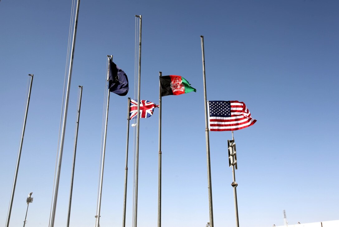 The American flag waves while flying at half-staff following the 9/11 ceremony held aboard Camp Leatherneck, Afghanistan, Sept. 11, 2014. The ceremony was attended by hundreds of Marines, sailors and coalition partners to commemorate the 13th anniversary of the terrorist attacks.