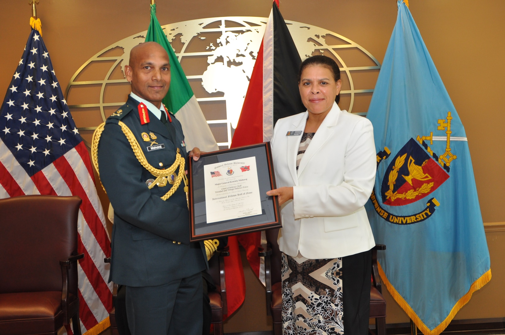 NDU Interim President Ambassador Wanda L. Nesbitt presents Major General Kenrick Maharaj of Trinidad and Tobago with a certificate confirming his induction into the International Fellows Hall of Fame on September 3, 2014.