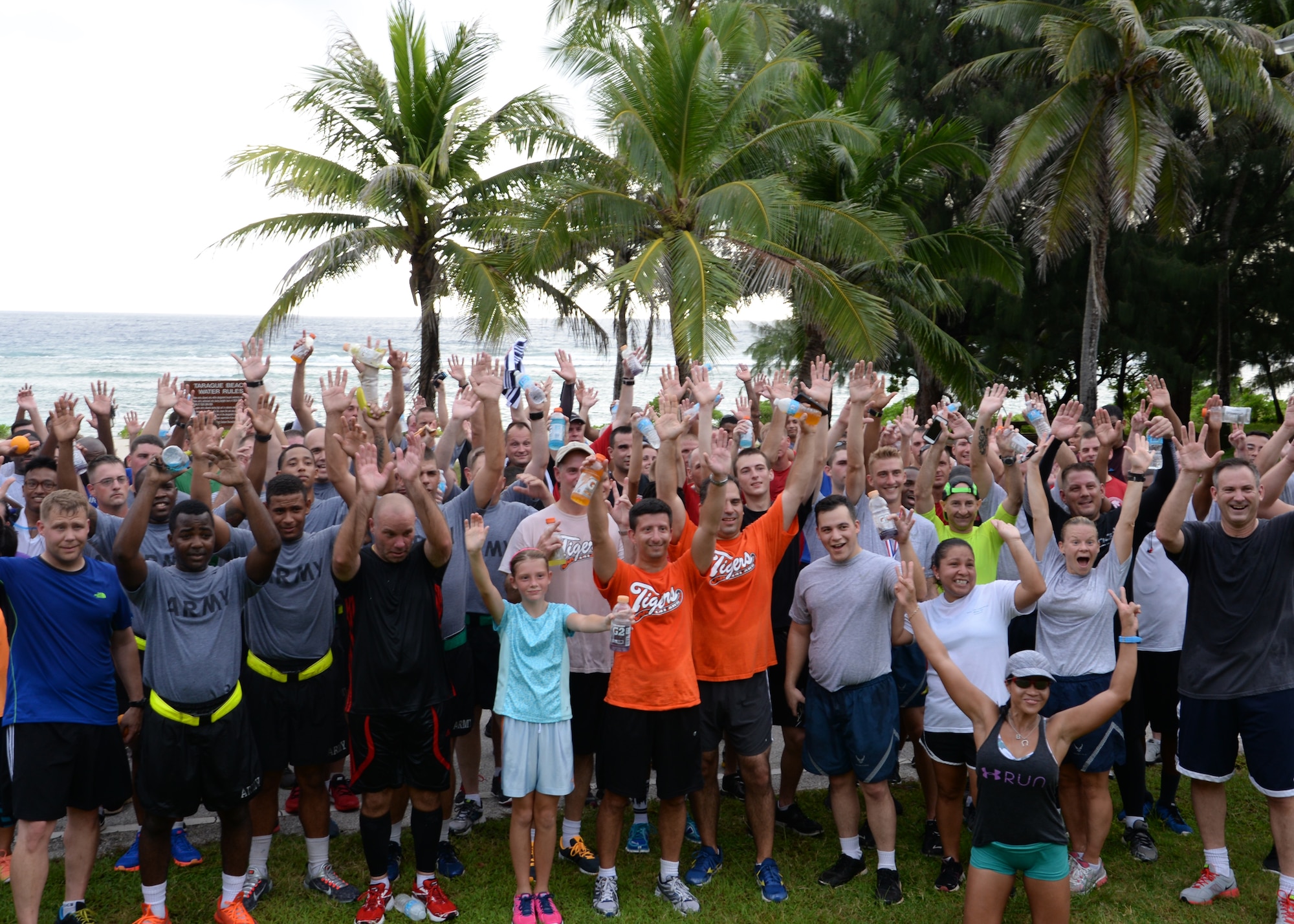 Participants in the Remembering our Heroes 5K cheer after completing the run at Tarague Beach Sep. 11, 2014, on Andersen Air Force Base, Guam. The run, which drew approximately 200 participants, was hosted by the Coral Reef Fitness Center and served as a tribute to the 9/11 tragedy that occurred Sept 11, 2001 in New York City and Washington D.C. when two airplanes were flown into the World Trade Center and Pentagon resulting in over 3,000 deaths including more than 400 police officers and firefighters. (U.S. Air Force photo by Senior Airman Cierra Presentado)