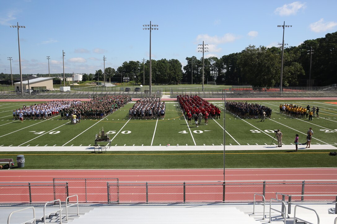 Marines with 2nd Marine Logistics Group, II Marine Expeditionary Force stand in formation at the beginning of the barracks bash at Goettge Memorial Field aboard Marine Corps Base Camp Lejeune, N.C., Aug. 27, 2014. Each unit sported a different color including white (Combat Lagistics Regiment 27), green (Combat Lagistics Regiment25), brown (Combat Lagistics Regiment 2), yellow (Dental Battalion), blue (Medical Battalion), and red (8th Engineer Support Battalion).