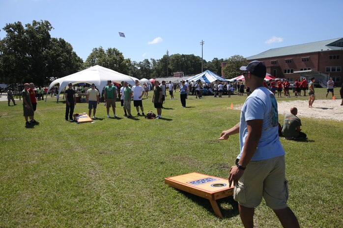 Marines with 2nd Marine Logistics Group, II Marine Expeditionary Force play a game of cornhole during the barracks bash at Goettge Memorial Field aboard Marine Corps Base Camp Lejeune, N.C., Aug. 27, 2014. The overall goal of the barracks bash was to maintain unit cohesion and build camaraderie amongst Marines by competing in several sporting events. (Marine Corps photo by Lance Cpl. Tyler Andersen)