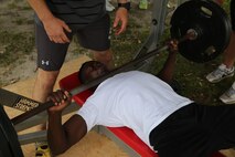 A Marine with 2nd Marine Logistics Group, II Marine Expeditionary Force participates in a weight lifting event during the barracks bash at Goettge Memorial Field aboard Marine Corps Base Camp Lejeune, N.C., Aug. 27, 2014. The overall goal of the barracks bash was to maintain unit cohesion and build camaraderie amongst Marines by competing in several sport events. (Marine Corps photo by Lance Cpl. Tyler Andersen)