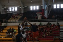 Marines with 2nd Marine Logistics Group, II Marine Expeditionary Force plays basketball during the barracks bash at Goettge Memorial Field aboard Marine Corps Base Camp Lejeune, N.C., Aug. 27, 2014. The overall goal of the barracks bash was to maintain  unit cohesion and build camaraderie amongst Marines by competing in several sport events. (Marine Corps photo by Lance Cpl. Tyler Andersen)