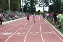 Marines with 2nd Marine Logistics Group, II Marine Expeditionary Force participate in a track and field event during the barracks bash at Goettge Memorial Field aboard Marine Corps Base Camp Lejeune, N.C., Aug. 27, 2014. The overall goal of the barracks bash was to maintain unit cohesion and build camaraderie amongst Marines by competing in several sport events. (Marine Corps photo by Lance Cpl. Tyler Andersen)