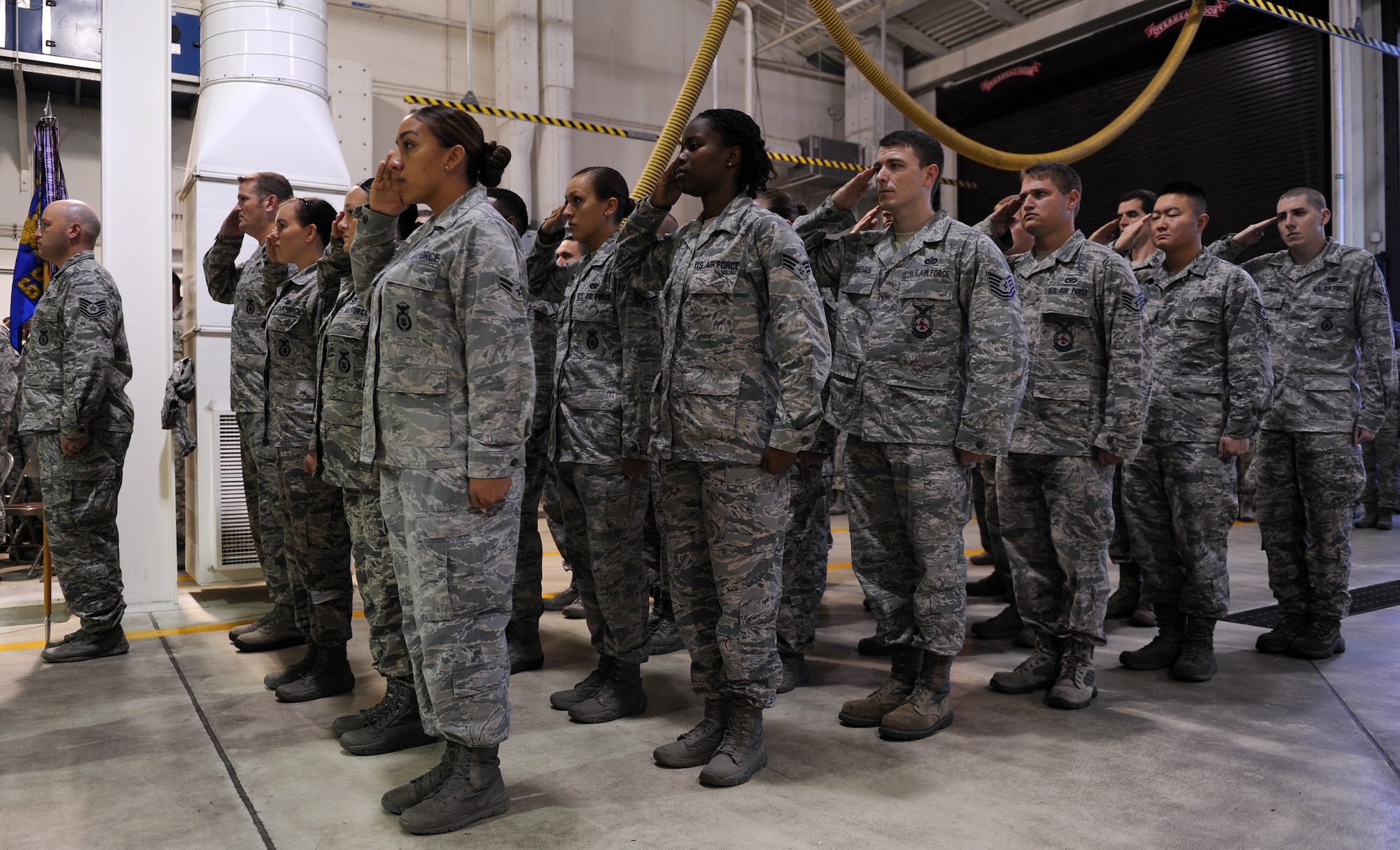 Members of the 65th Security Forces Squadron salute during the United States national anthem at a 9/11 Remembrance Ceremmony at Lajes Field, Azores, Portugal Sept. 11, 2014. Airmen from Lajes honored those that lost their lives in the 9/11 attacks by committing to remember them throughout the day. (U.S. Air Force photo/Staff Sgt. Zachary Wolf)