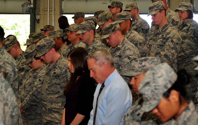 Air Force servicemembers and civilians stand and observe a moment of silence during the 9/11 ceremony at Misawa Air Base, Japan, Sept. 11th 2014. They are reminded of that fateful day 13 years ago when the United States, Japan and the rest of the world changed forever. (U.S. Air Force photo/Tech. Sgt. April Quintanilla)