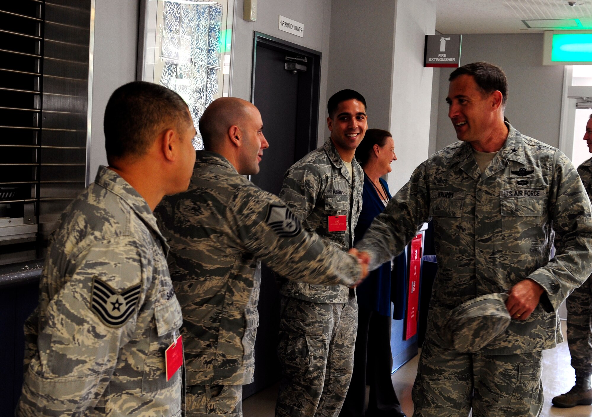 Brig. Gen. David Krumm, 5th Air Force vice commander, shakes the hands of Airmen from the 733rd Air Mobility Squadron during his visit to Kadena Air Base, Japan, Sept. 8, 2014. During the visit he toured the passenger terminal and learned about its mission and about the special programs they offer like Space A and virtual roll call. (U.S. Air Force by Airman 1st Class Keith James/Released)