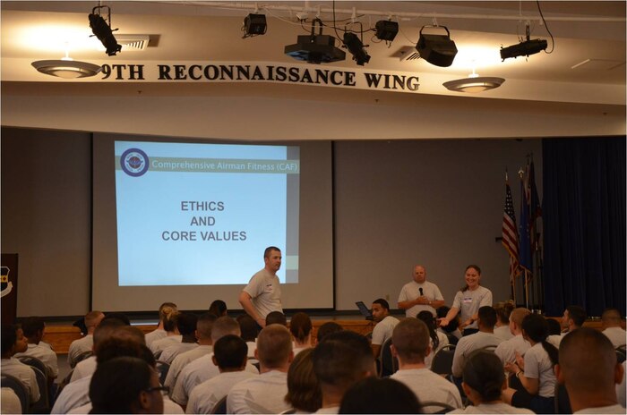 Members of the 9th Reconnaissance Wing listen to a Comprehensive Airman Fitness day briefing at Beale Air Force Base, Calif., Sept. 8, 2014.  The event emphasized physical fitness and covered topics on nutrition, sleep and stress.  (Courtesy photo)