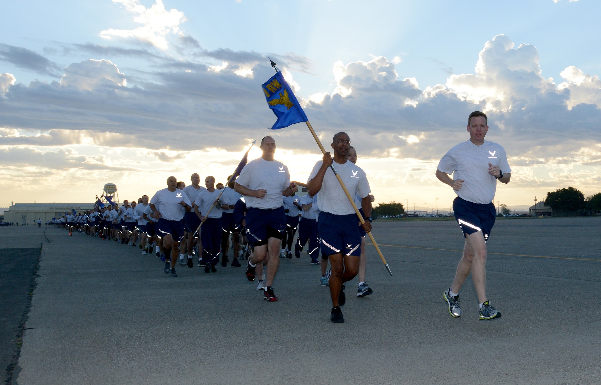 Col. Douglas J. Lee, 9th Resonnaissance Wing commander and Chief Master Sgt. Leslie N. Gould, 9th Reconnaissance Wing Command Chief lead the wing run at Beale Air Force Base, Calif., Sept. 8, 2014.  The flight line run was part of a Comprehensive Airman Fitness day focused on building resiliency through physical fitness. (U.S. Air Force photo by John Schwab/Released)