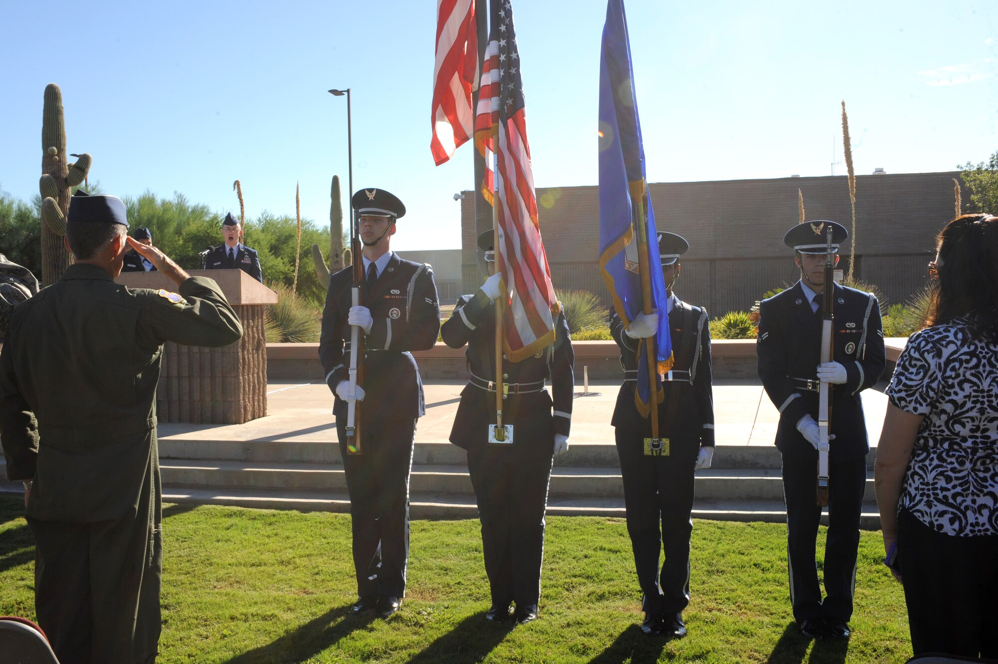 U.S. Air Force honor guardsmen present arms prior to the National Anthem being sung by Master Sgt. Charles Edwards, 548th Intelligence Surveillance Reconnaissance Group superintendent, during a 9/11 Remembrance ceremony at Davis-Monthan Air Force Base, Ariz., Sept. 11, 2014. The ceremony was held in honor of those who lost their lives during Sept. 11 attacks. (U.S. Air Force photo by Airman 1st Class Cheyenne Morigeau/Released) 