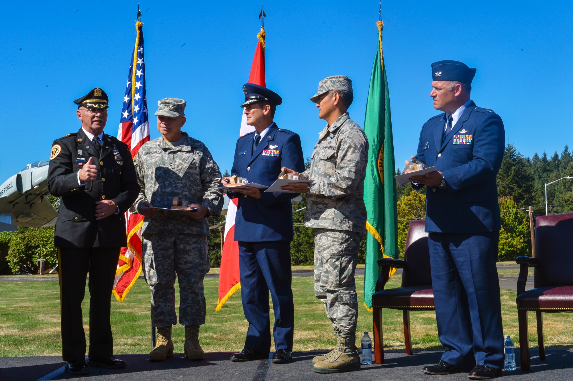 Far left, Steven Saymon, retired Brooklawn Police Department police inspector, presents gifts, symbolic to the 2001 attacks to, from left to right, Maj. Gen. Bret Daugherty, Washington National Guard Adjutant General, Brig. Gen. John Tuohy, Washington Air National Guard commander, Col. David Kumashiro, 62nd Airlift Wing commander and Col. Pete Stavros, Western Air Defense Sector commander. The gifts included a knife made of steel from the World Trade Center, soil from the Flight 93 crash site, and rubble stones from the Pentagon. (U.S. Air Force photo/Staff Sgt. Russ Jackson)