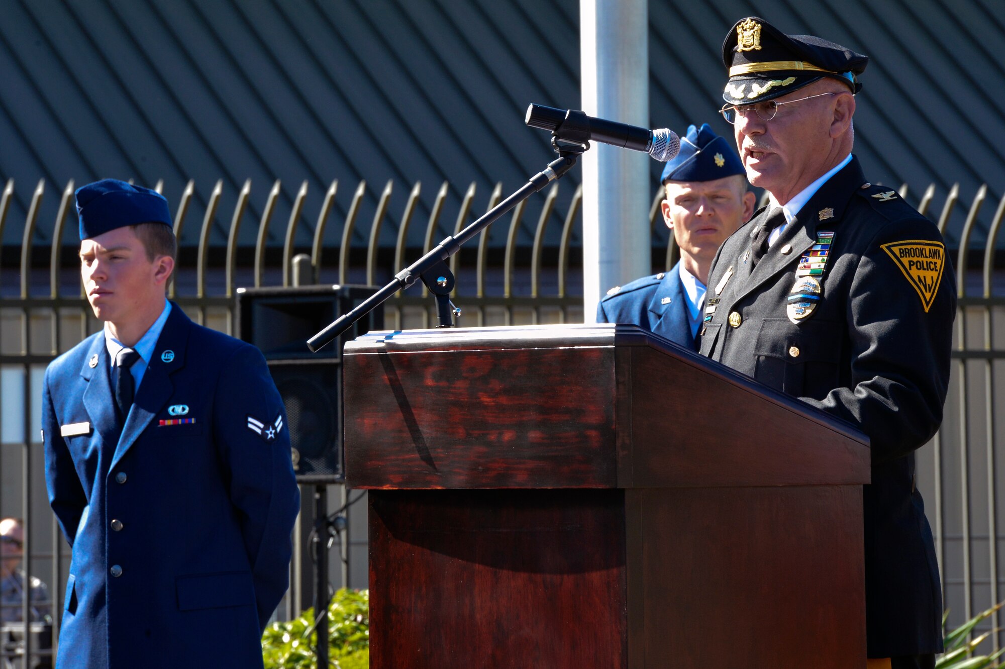 Steven Saymon, retired Brooklawn Police Department police inspector, describes his account of the World Trade Center attacks in New York during the WADS 9/11 memorial ceremony Sept. 11, 2014, at Joint Base Lewis-McChord, Wash. Saymon was a first responder to the World Trade Center disaster and has assisted dozens of organizations across America in their acquisition of artifacts from the three disaster sites. (U.S. Air Force photo/Staff Sgt. Russ Jackson) 