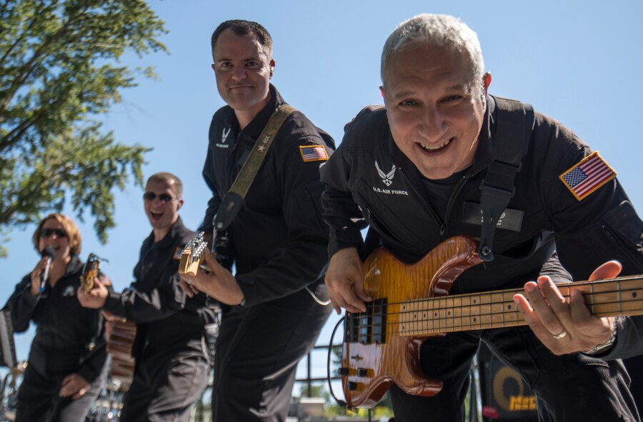 Members of Mobility look at the camera during a song at Air Force Appreciation Day in Mountain Home, Idaho, Sept. 6, 2014. Mobility is a subdivision of the U.S. Air Force Band of the Golden West, who played numerous sets all around southern Idaho during their six day tour. (U.S. Air Force photo by Airman 1st Class Brittany A. Chase/Released)