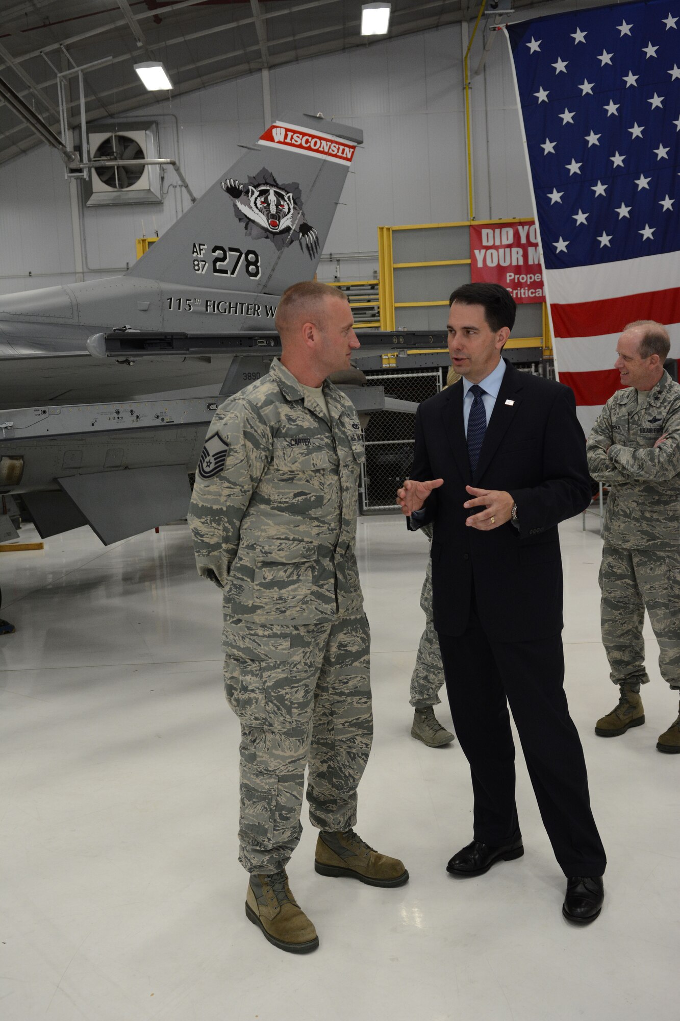 Governor Scott Walker, Wisconsin governor, takes a moment to speak with Master Sgt. Richard Carter, 115th Fighter Wing senior non-commissioned officer of the quarter, following his speech about Sept. 11, 2001, in Hangar 406 at the 115 FW in Madison, Wis., Sept. 11, 2014. Walker visited the base to thank the Airmen for serving their country and state. (Air National Guard photo by Senior Airman Andrea F. Liechti)