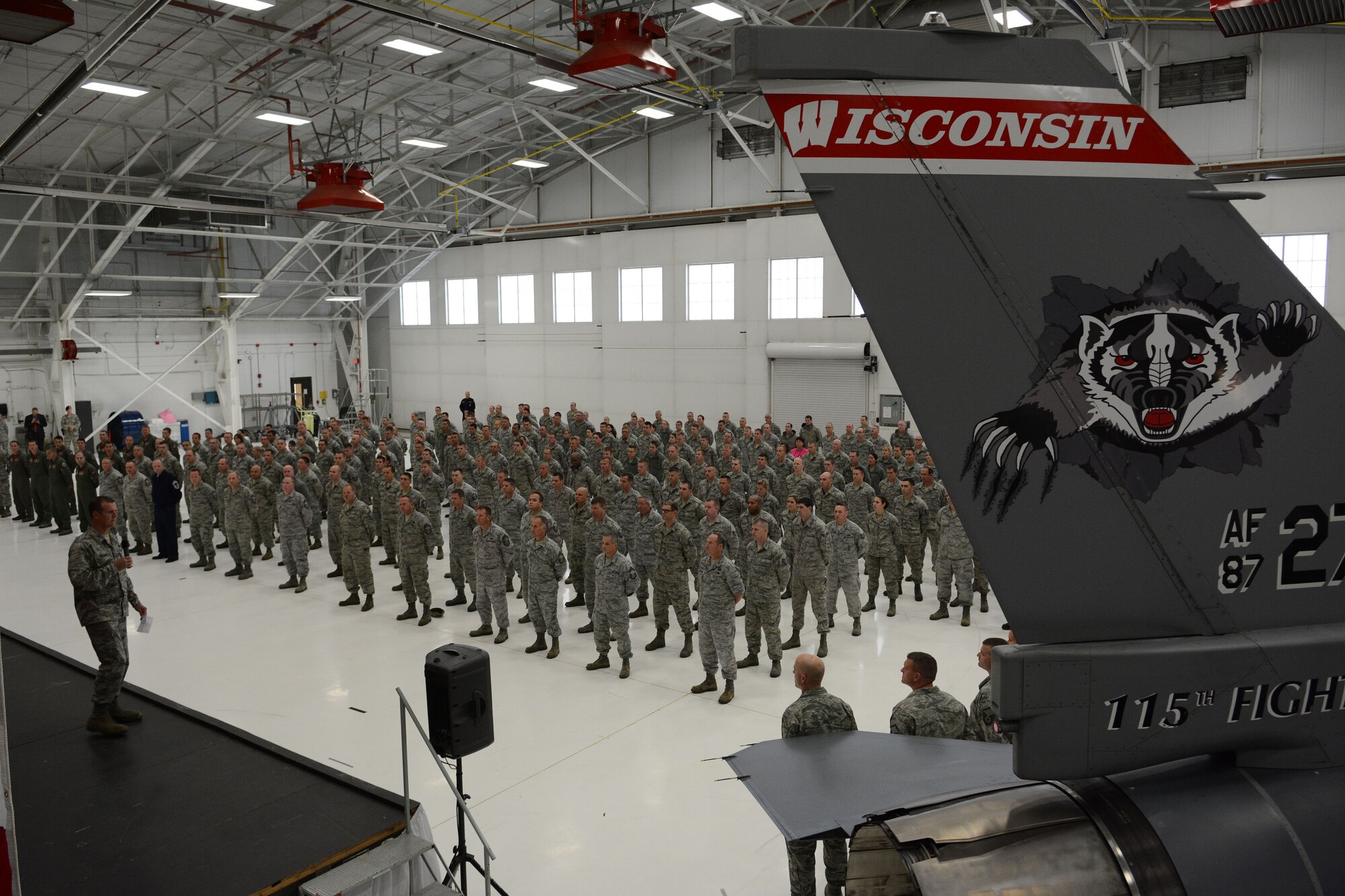 Col. Jeffrey Wiegand, 115th Fighter Wing commander, talks about the events of Sept. 11, 2001 prior to introducing Governor Scott Walker, Wisconsin governor, during a formation in Hangar 406 at the 115 FW in Madison, Wis., Sept. 11, 2014. Walker visited the base to thank the Airmen for serving their country and state. (Air National Guard photo by Senior Airman Andrea F. Liechti)