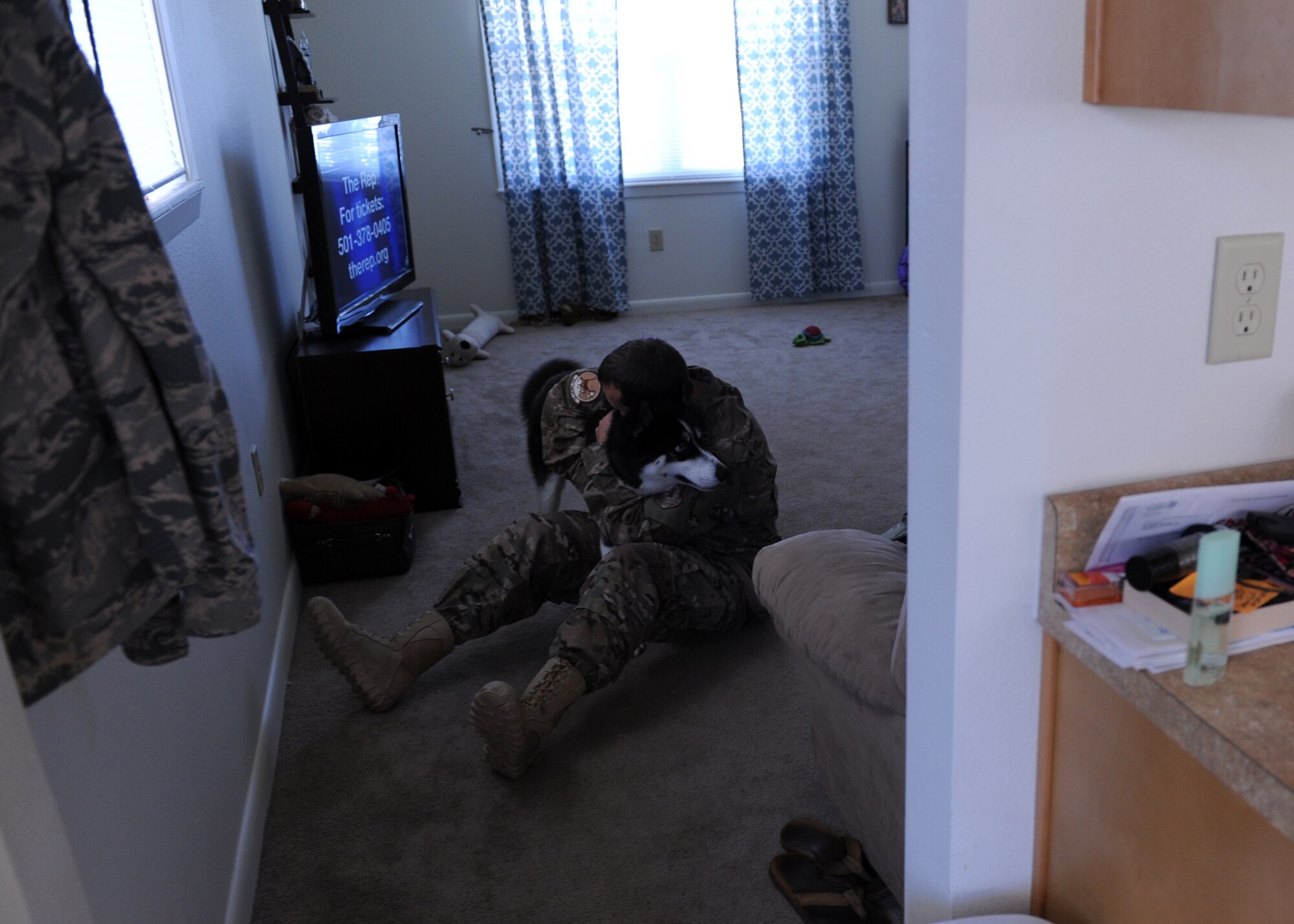 Senior Airman Nathan Smith, a 61st Airlift Squadron aviation resource manager, hugs his dog Kuzco, before leaving on his first deployment Sept. 5, 2014, at Little Rock Air Force Base, Ark. Smith will be deployed for six months supporting combat airlift operations in Afghanistan. (U.S. Air Force photo by Airman 1st Class Cliffton Dolezal)