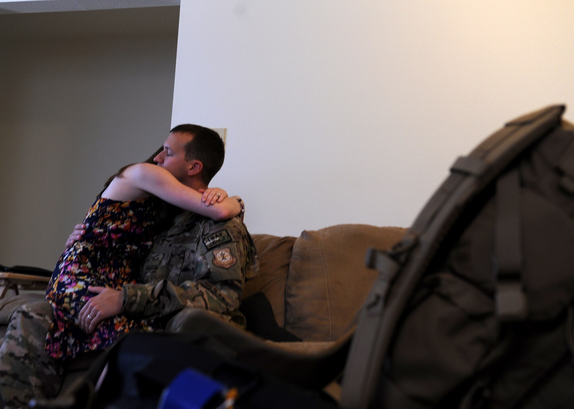 Senior Airman Nathan Smith, a 61st Airlift Squadron aviation resource manager, comforts his wife, Ashley, Sept. 5, 2014, at Little Rock Air Force Base, Ark. When the morning of Smith’s deployment arrived, Smith and Ashley woke early to make the most of their remaining time together for the next six months. (U.S. Air Force photo by Airman 1st Class Cliffton Dolezal) 