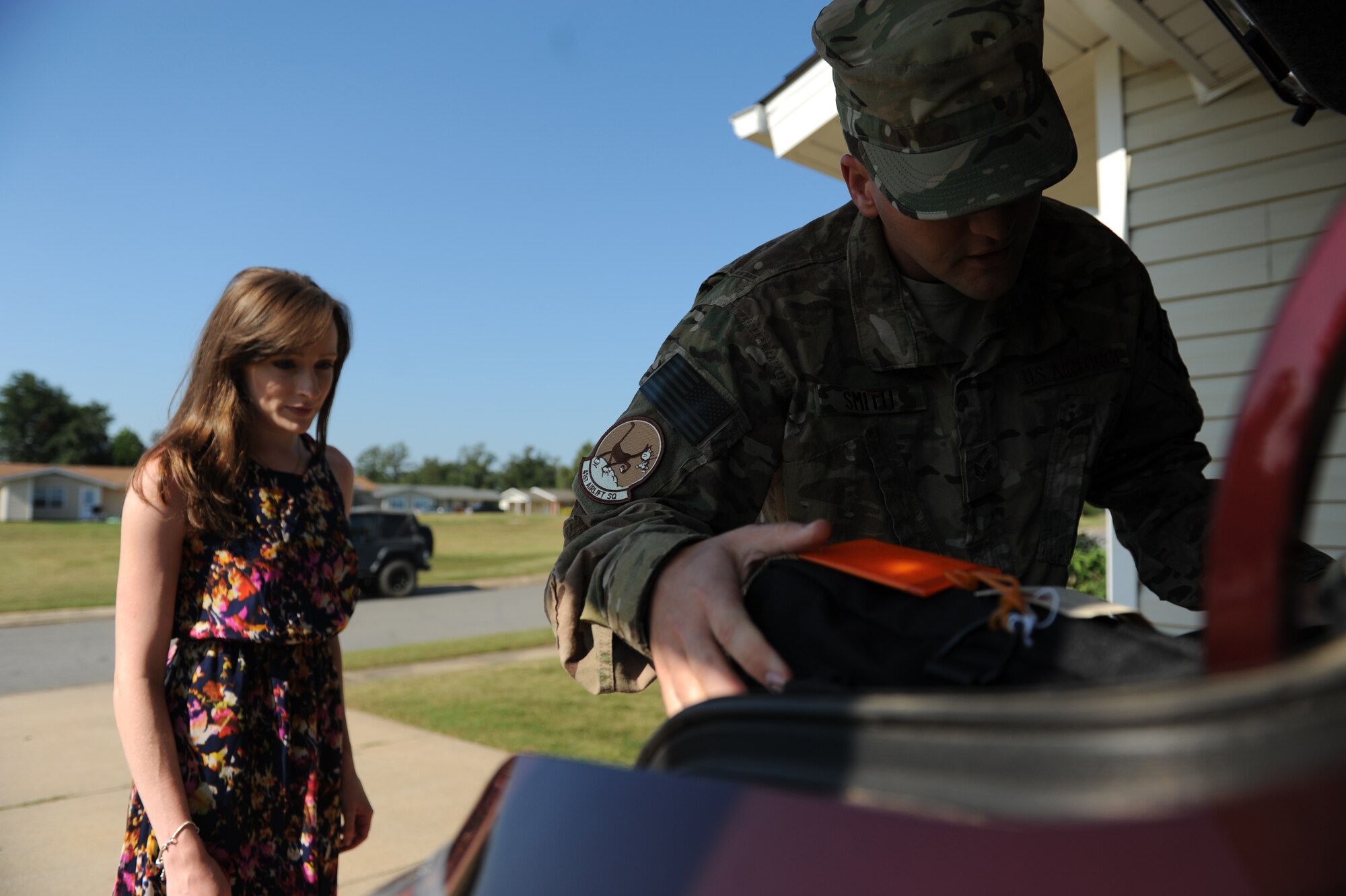 Senior Airman Nathan Smith, a 61st Airlift Squadron aviation resource manager, loads up his deployment gear as his wife, Ashley, watches Sept. 5, 2014, at Little Rock Air Force Base, Ark. There are many burdens military spouses must carry including the challenges of supporting their loved ones when they are called to serve overseas. (U.S. Air Force photo by Airman 1st Class Cliffton Dolezal)