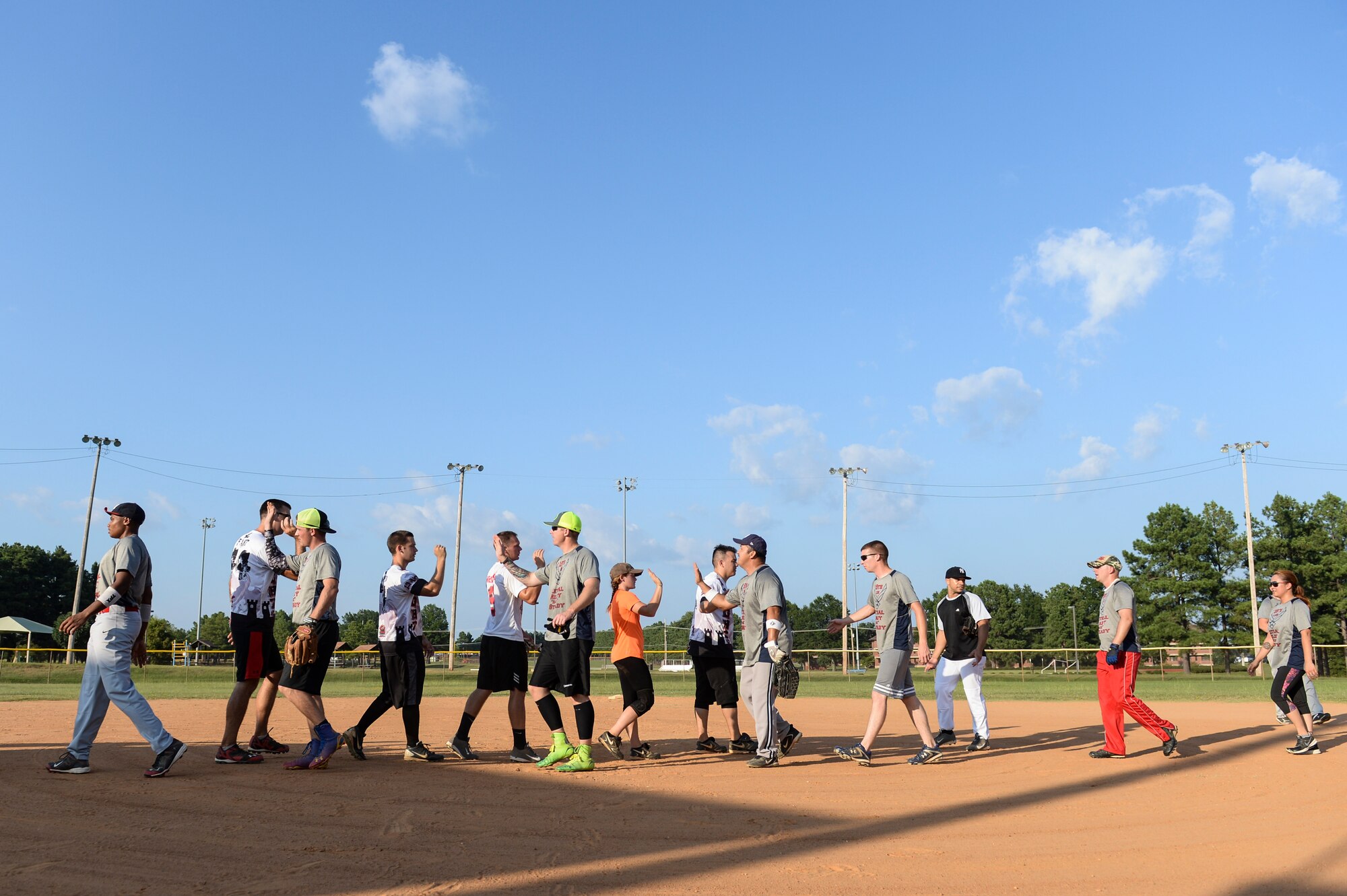 The 19th Logistics Readiness Squadron and 19th Aircraft Maintenance Squadron congratulate each other after the intramural softball championship game Aug. 27, 2014 at Little Rock Air Force Base, Ark. The 19th LRS defeated the 19th AMXS 18-5. (U.S. Air Force photo by Airman 1st Class Cliffton Dolezal)